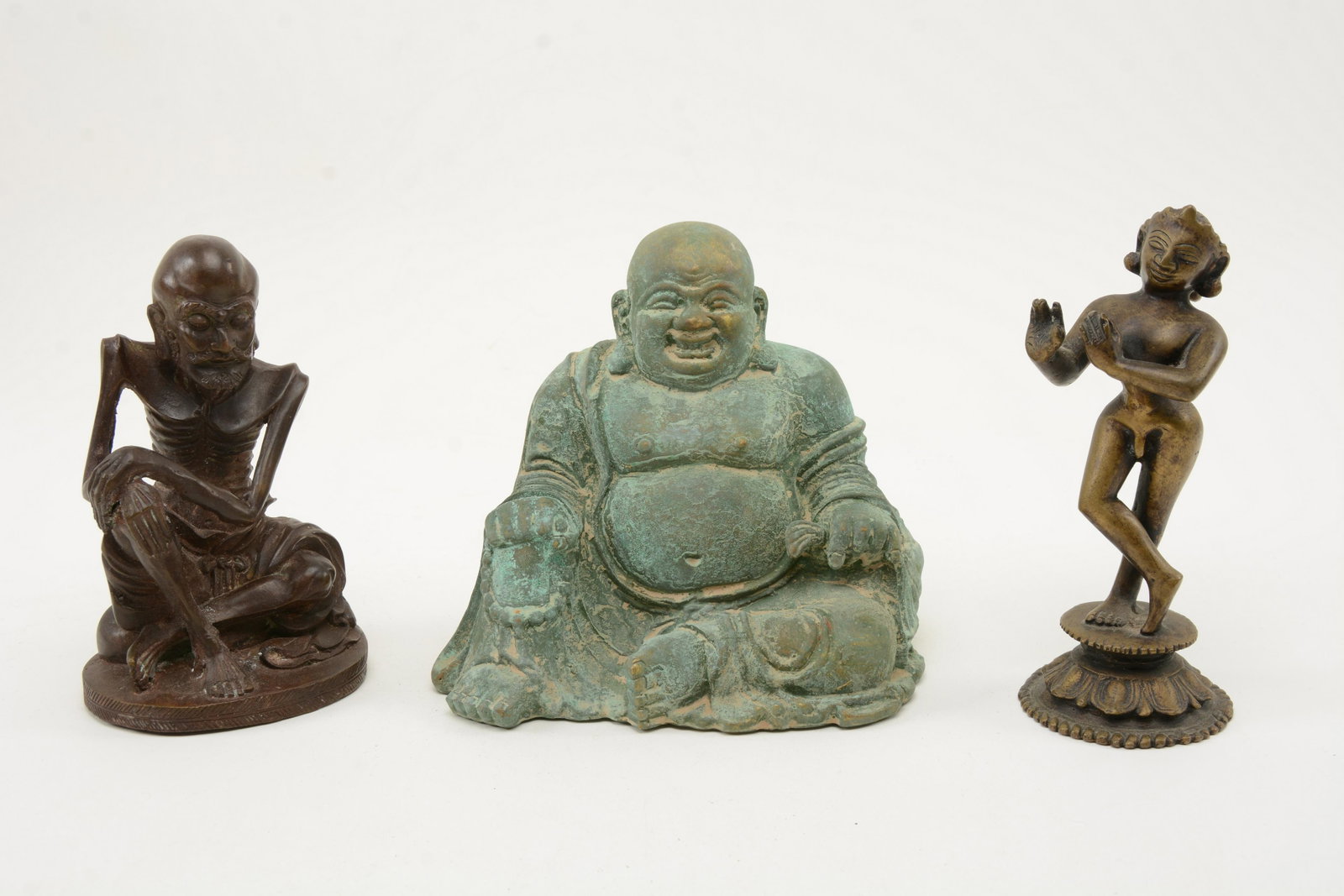 Chinese Cast Bronze Buddha Figures. Lot of [3]: Cast Bronze Buddha Figures. Lot of [3] figures including seated and thin depictions. Possible repairs to underside of one. Seated Buddha measures 6” tall.