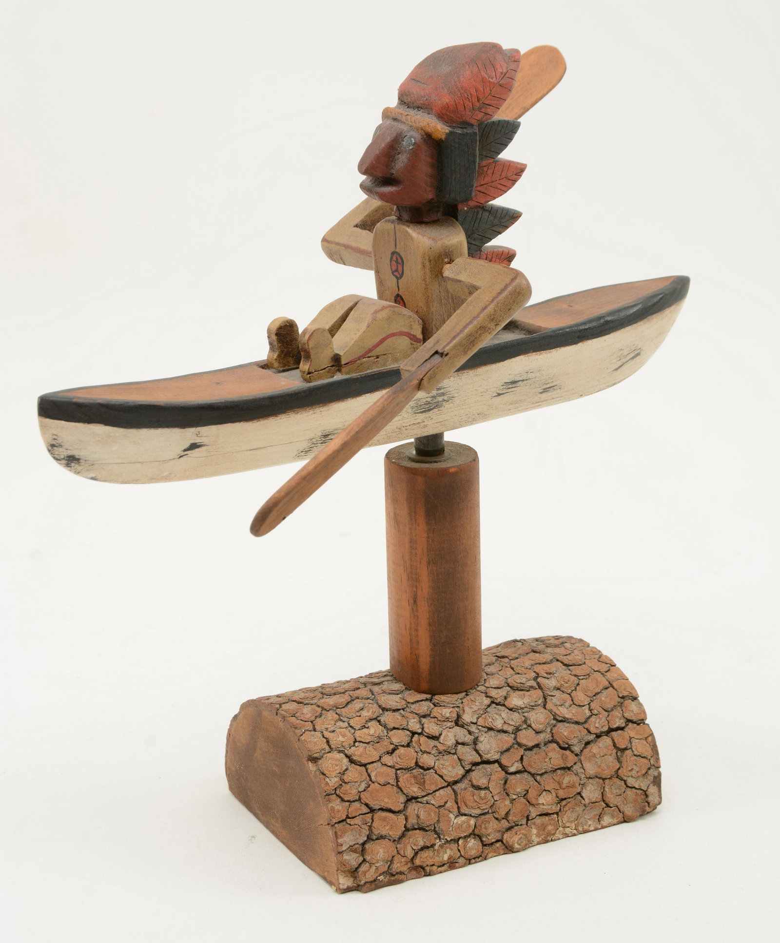T.B. Alfred Folk art whirly-gig of native in a canoe: Folk art whirly-gig of native in a canoe on a natural wood base. Marked T/B Alfred #12/45 1999.