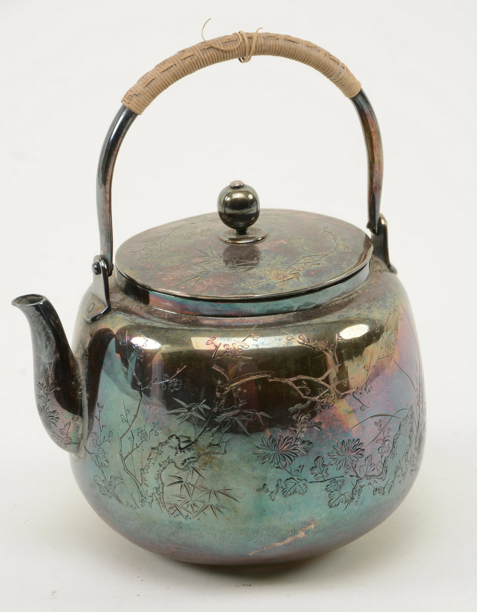 Japanese Silver Teapot. Etched bamboo and floral scenes: Japanese Silver Teapot. Etched bamboo and floral scenes to sides. Tarnishing. 6.75” high including handle.