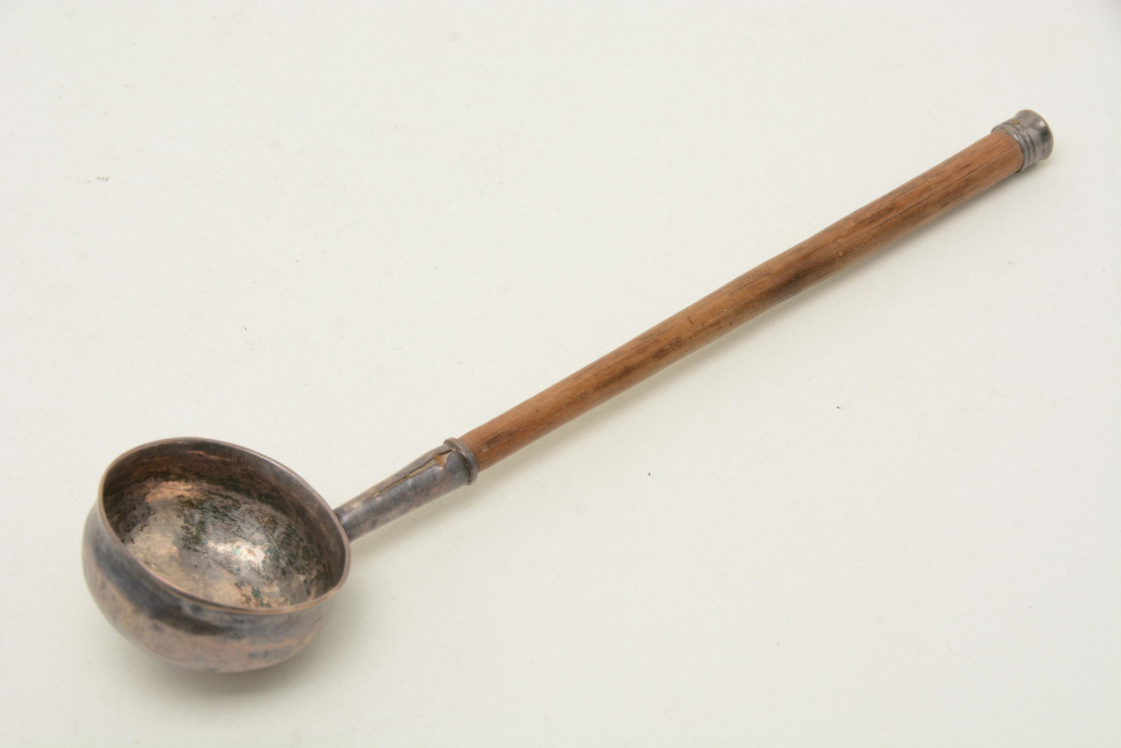 Colonial American Coin silver Ladle, ca. 1720. Marked: Colonial American Coin silver Ladle, ca. 1720. Marked IG (in an ellipse). silver cap at end of wooden handle. Probably by John Gardiner of New London, CT. Eighteenth century. Length 9-5/8". Bowl diame