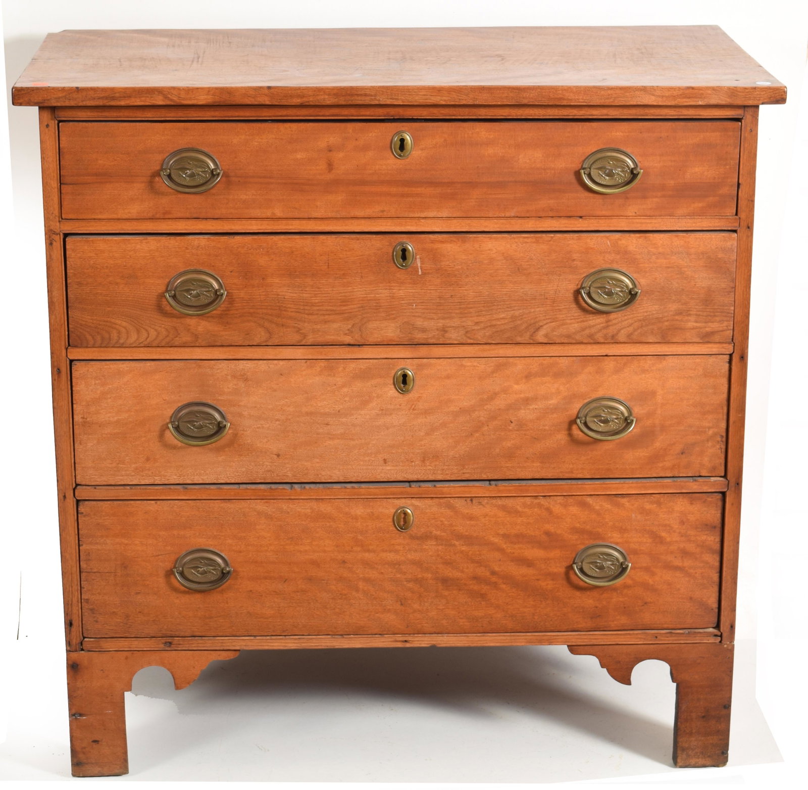 Chippendale birch chest of drawers on cut out bracket: Chippendale birch chest of drawers on cut out bracket feet, New England circa 1780. Four graduated drawers with replaced pressed brass hardware. 38.5” height, 39” width. 19.75” depth