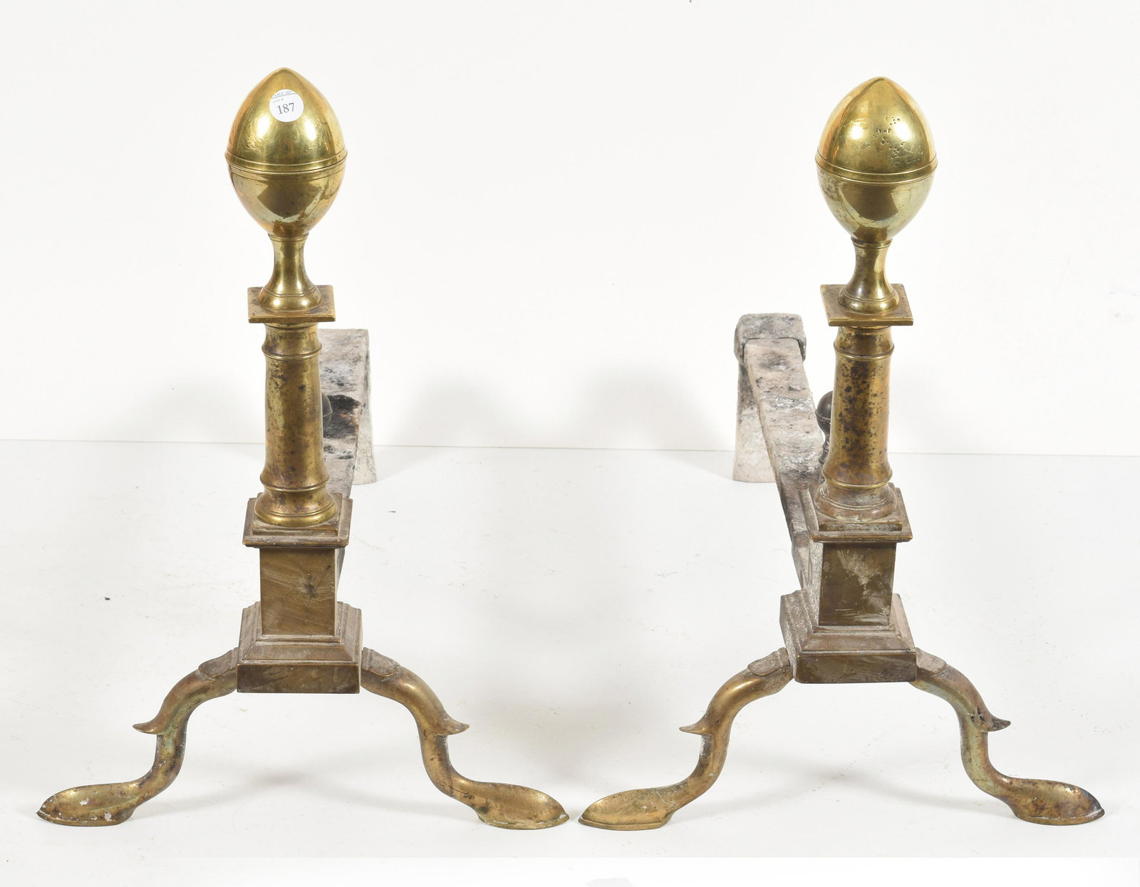 Pair of brass lemon top andirons with matching logs: Pair of brass lemon top andirons with matching logs stops on cabriole legs and slipper feet 20” height, 22” depth From the David Thomas Collection