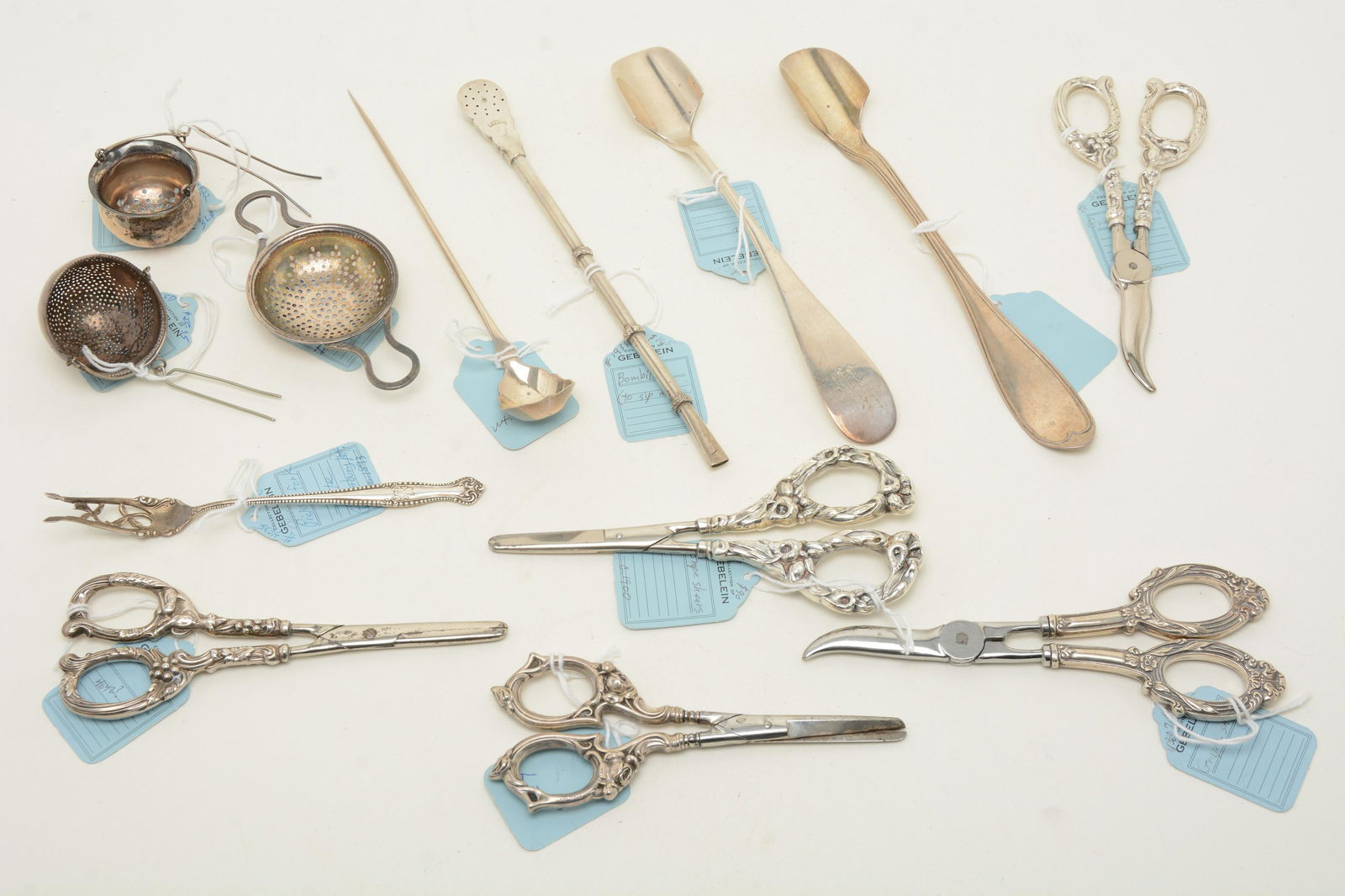 Assorted sterling silver serving utensils and: Assorted sterling silver serving utensils and tableware. Includes 5 pairs of grape shears, American coin silver mote spoon, bombilla spoon, 3 tea strainers (2 by International), a Towle pickle fork, a