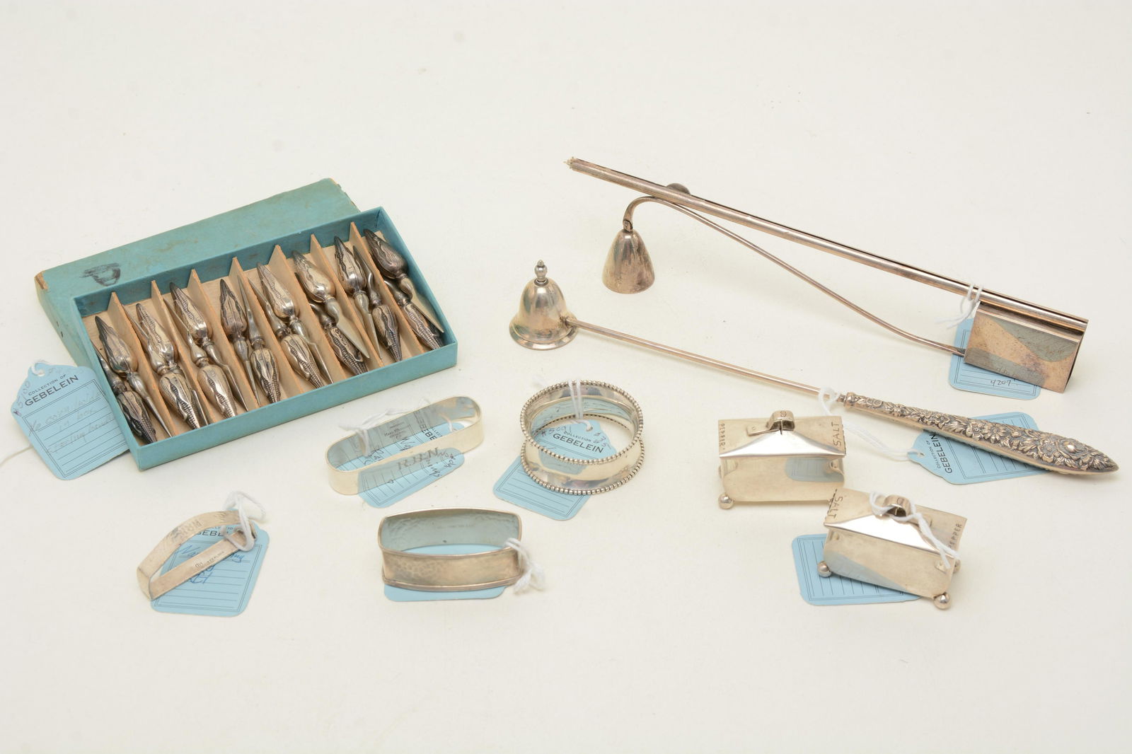 Sterling silver tableware and accessories. 20th: Sterling silver tableware and accessories. 20th century. Includes 4 assorted napkin rings, salt and pepper cellars by MHJ, 2 candle snuffers by Napier and S. Kirk & Son, and a set of 16 figural corn h