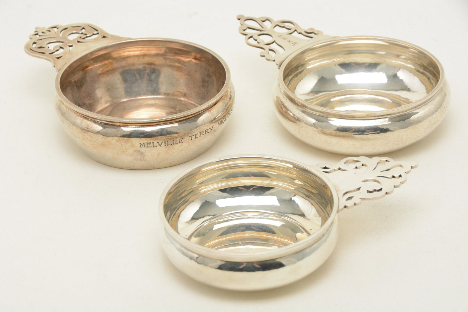 Sterling silver Porringers by Carlson, Leinonen, and: Sterling silver Porringers by Carlson, Leinonen, and Gyllenberg. David Carlson piece with Thick gauge silver, traditional handle. Diameter 4-3/8". Maximum horizontal dimension 6-3/4". Height 1-1/2". W