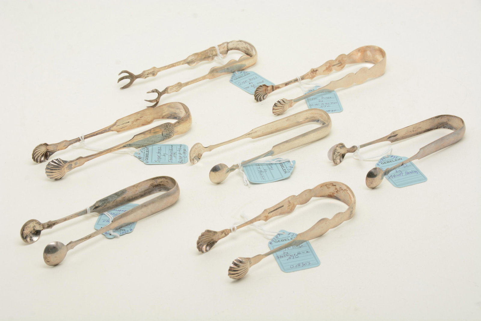 19th Century American coin silver tongs. [7] total: 19th Century American coin silver tongs. [7] total pieces by Newell Harding (Boston), Ward (Philadelphia), Stebbins & Howe (NYC), G. W. Striker (NYC), and J. J. Bigelow. 9.40 ozt total weight. 6.75