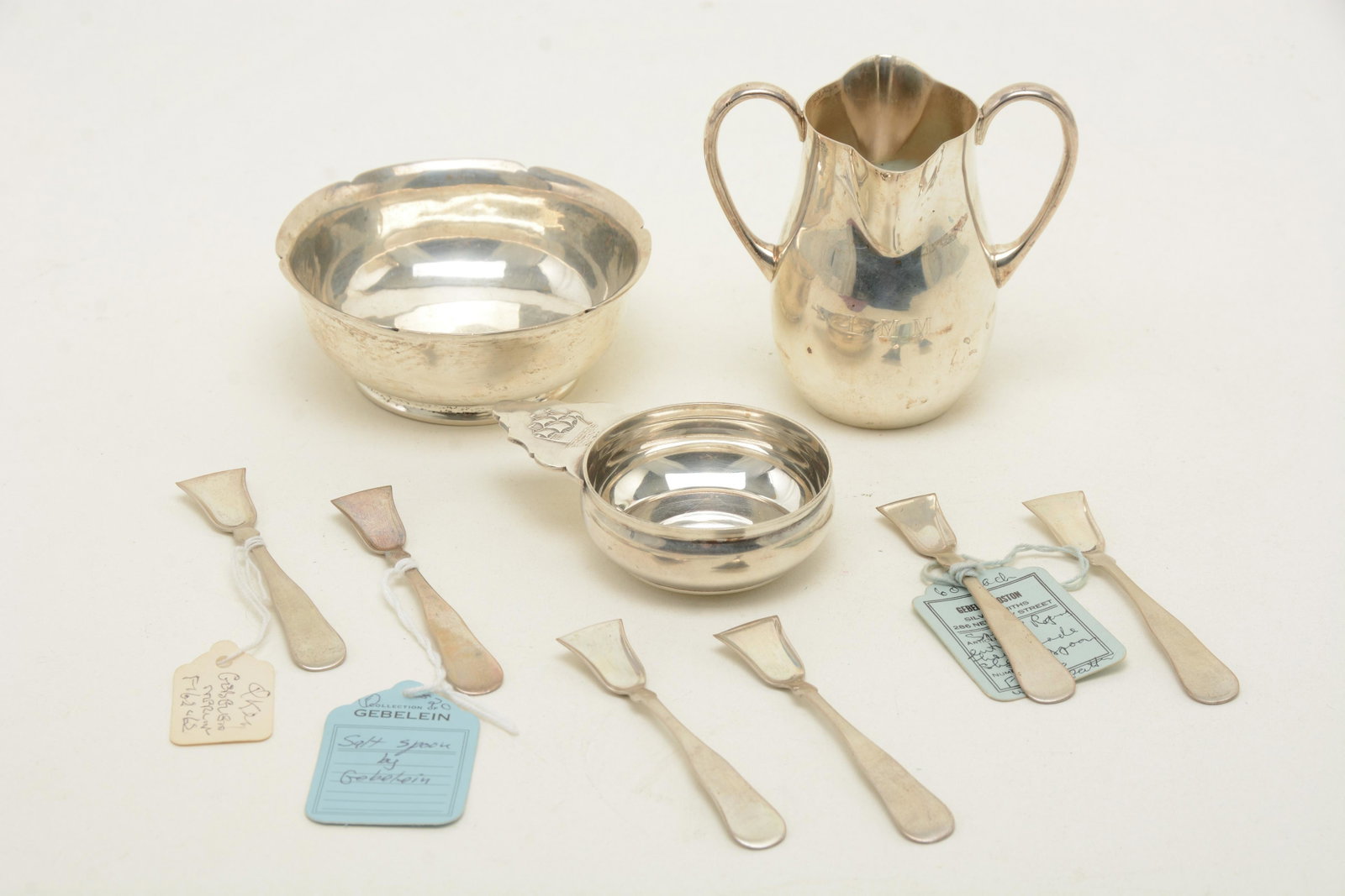 Gebelein sterling silver bowl, pitcher, and porringer.: Gebelein sterling silver bowl, pitcher, and porringer. Together with set of [6] salt shovels. Mid-20th century. Footed bowl with small rim cut-outs, double handled cream pitcher with NES monogram, and