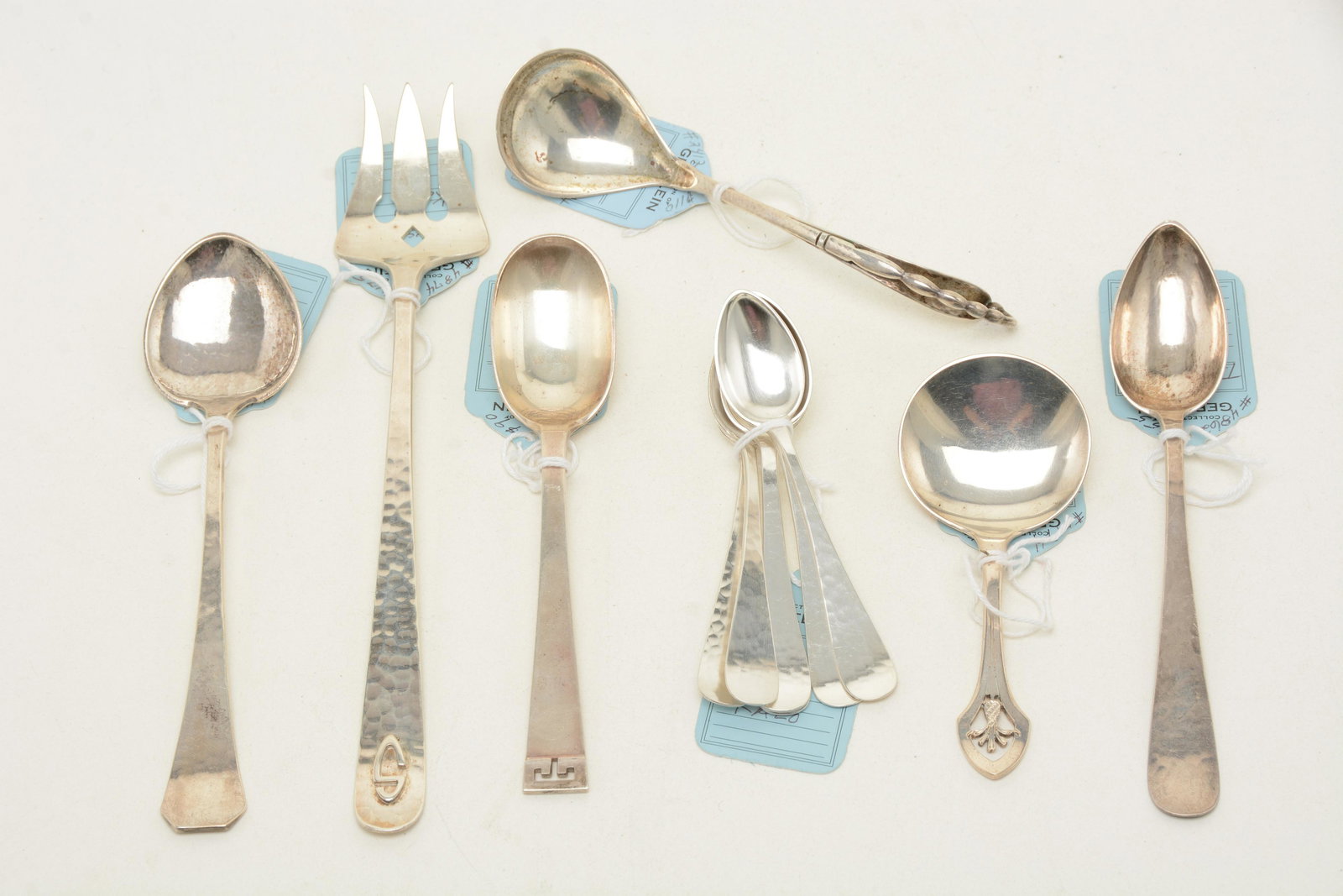 Arts & Crafts style sterling silver utensils. Includes: Arts & Crafts style sterling silver utensils. Includes set of [6] demitasse spoons by Kalo, long teaspoon by Kalo, lettuce fork by Kalo, small spade form serving spoon by Kalo, spoon by Allen Adler, t