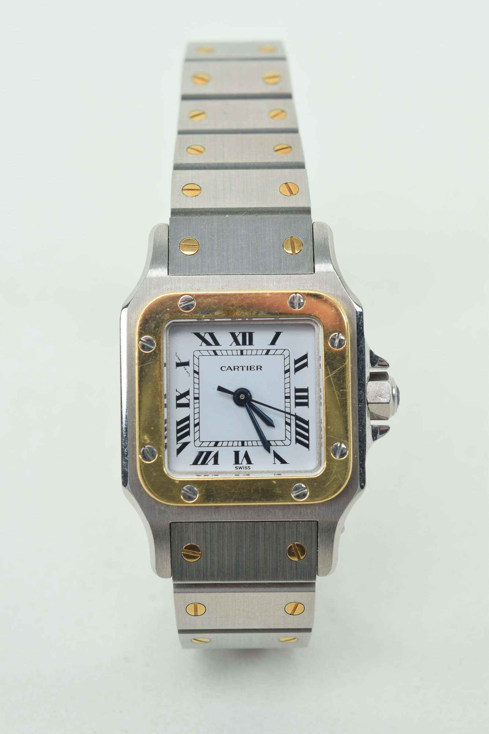 Cartier Santos ladies' automatic watch. Stainless steel: Cartier Santos ladies' automatic watch. Stainless steel and 18k yellow gold. Case measures 24mm, square shape with yellow gold bezel. White dial, with black Roman numeral markers, and blued hands. Bra