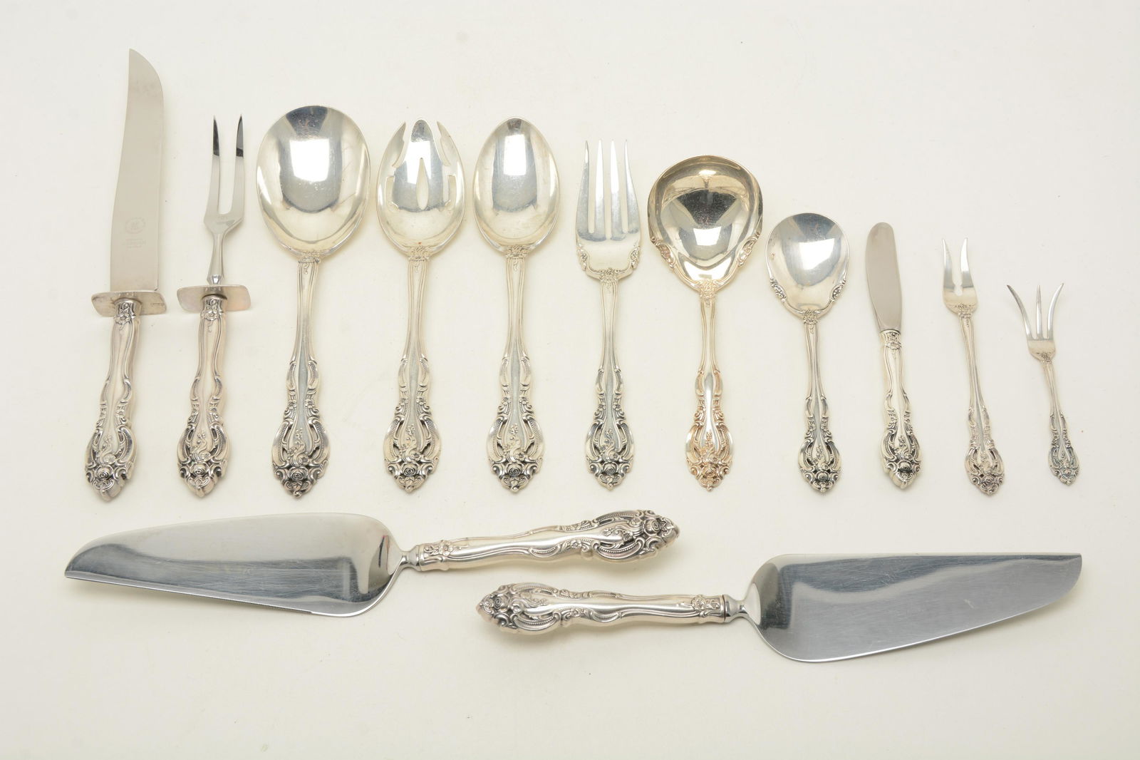 Gorham “La Scala” sterling silver serving utensils. Lot: Gorham “La Scala” sterling silver serving utensils. Lot of [13] pieces including carving set, pie servers, butter knife, olive and pickle forks, serving spoons and forks. 19.33 ozt total w