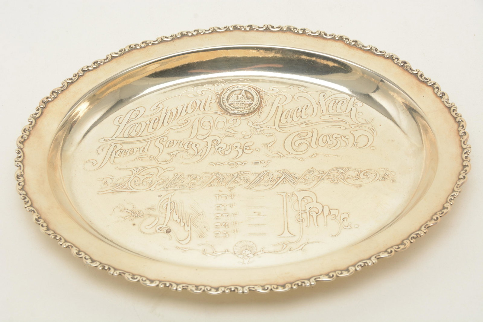 Whiting sterling silver oval trophy with acid edge: Whiting sterling silver oval trophy with acid edge decoration. “Larchmont Race Week. 1902. Record Series Prize. Class D. Won by ?? July. 1st Prize.” Scroll border. Small ding on side at ba