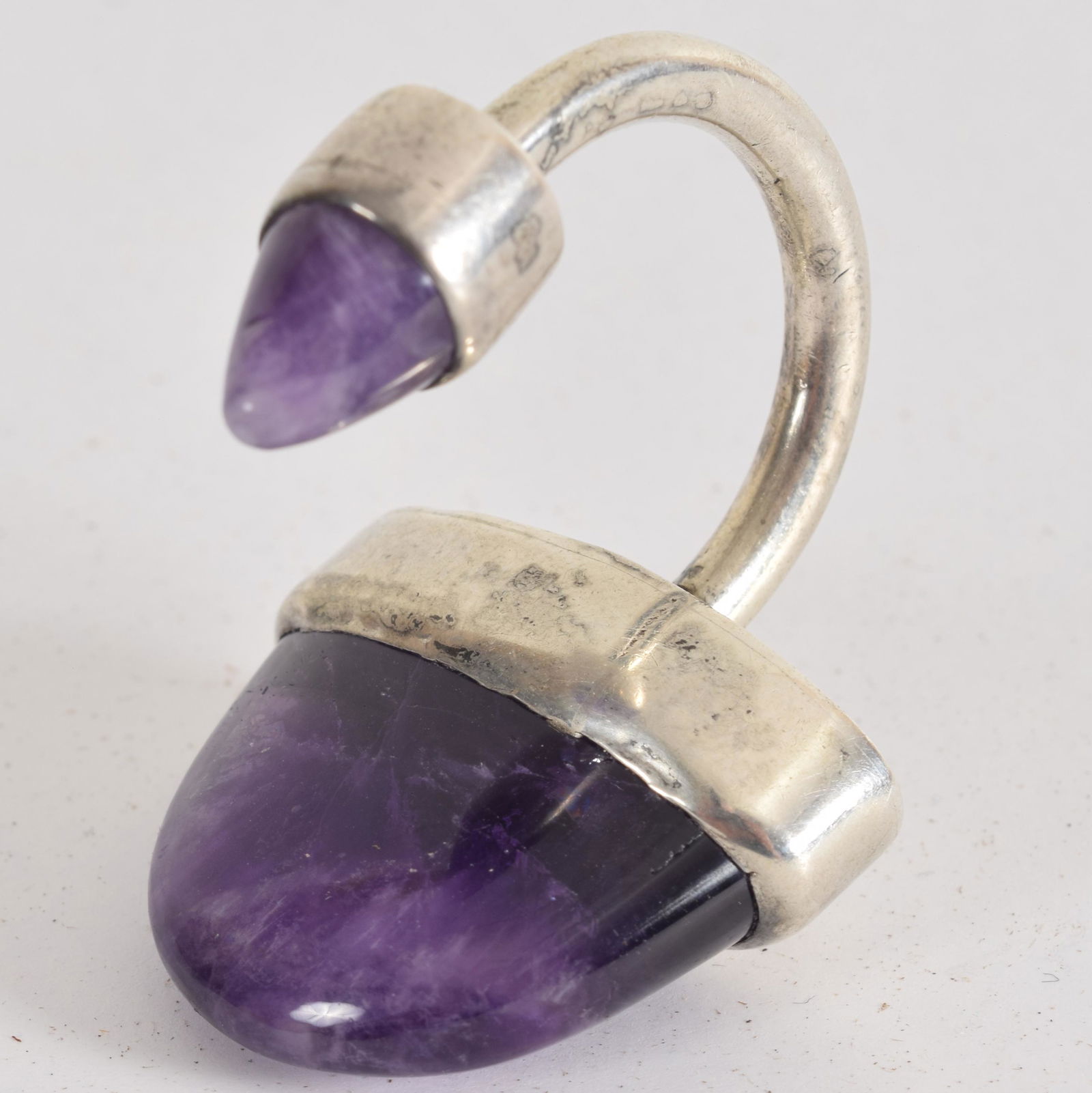 Mexican Sterling silver key ring set with two purple: Mexican Sterling silver key ring set with two purple stones. Makers mark Hubert Harmon. 1.5” height.