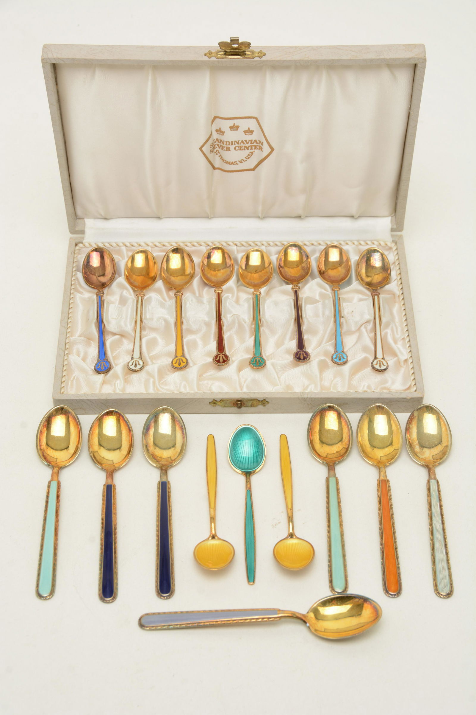 Lot of Norway enameled sterling silver spoons. 1) Cased: Lot of Norway enameled sterling silver spoons. 1) Cased lot of 8 David Andersen gilt enameled demitasse spoons. Marked D.A. Good condition. 3.75” length. 2) [7] Norway sterling silver enameled s