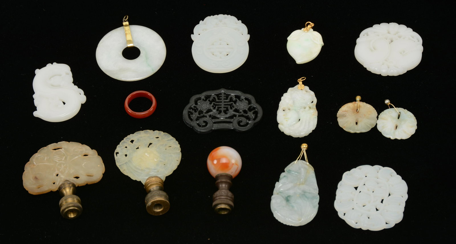 Three Hardstone Finials and Group of 11 Jade Pendants,: Three Hardstone Finials and Group of 11 Jade Pendants, China 19/20th century. Two openwork jade finials (one circular, one fan-shaped) and the third , a carnelian ball.