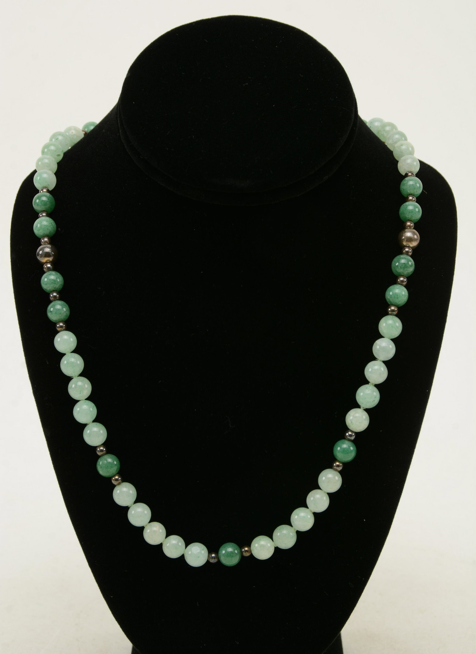 Chinese jadeite bead necklace with silver beads. Good: Chinese jadeite bead necklace with silver beads. Good translucent green and white color. Some beads with inclusions. Approximately 5/16 in diameter on jadeite beads 15 in long closed
