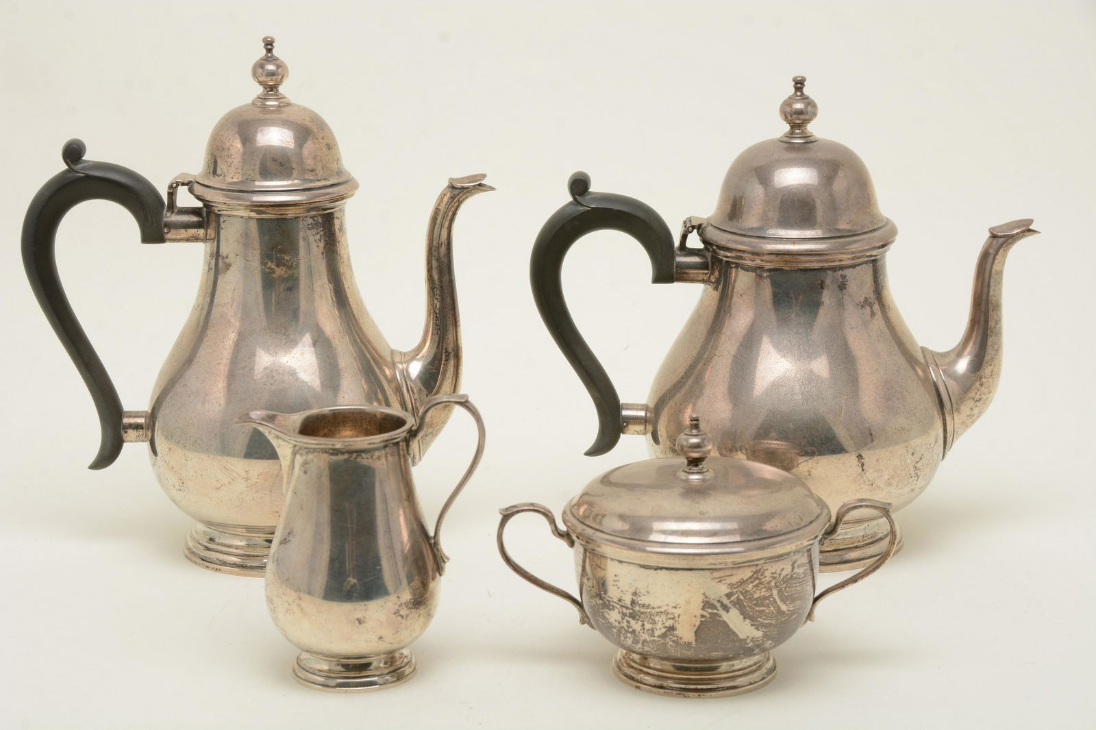 Tiffany & Co. Makers sterling silver four-piece tea: Tiffany & Co. Makers sterling silver four-piece tea set. Colonial style forms. Steeple finials. Coffee pot- 9.75in high. Good condition. Inscribed numbers on bases. 77.7 ozt total weight