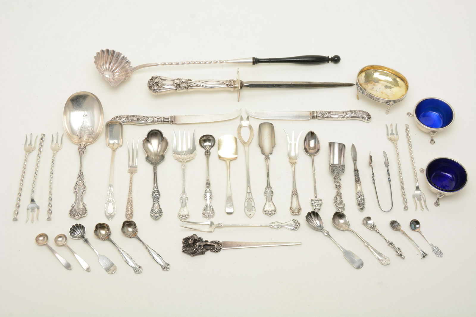 Group of sterling and coin silver, footed salts,: Group of sterling and coin silver, footed salts, serving and sugar spoons, etc. 16.7 ozt. Along with (2) silver handle cheese knives, a sharpening steel and a CHRISTOFLE toddy ladle.