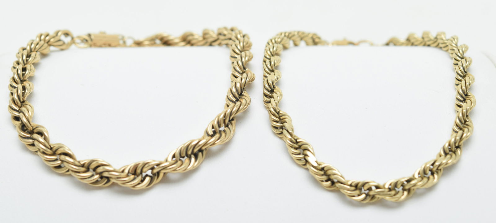 2 gold twisted rope link bracelets. One marked 14k,: 2 gold twisted rope link bracelets. One marked 14k, cir. 8in and 7in. 32 grams.