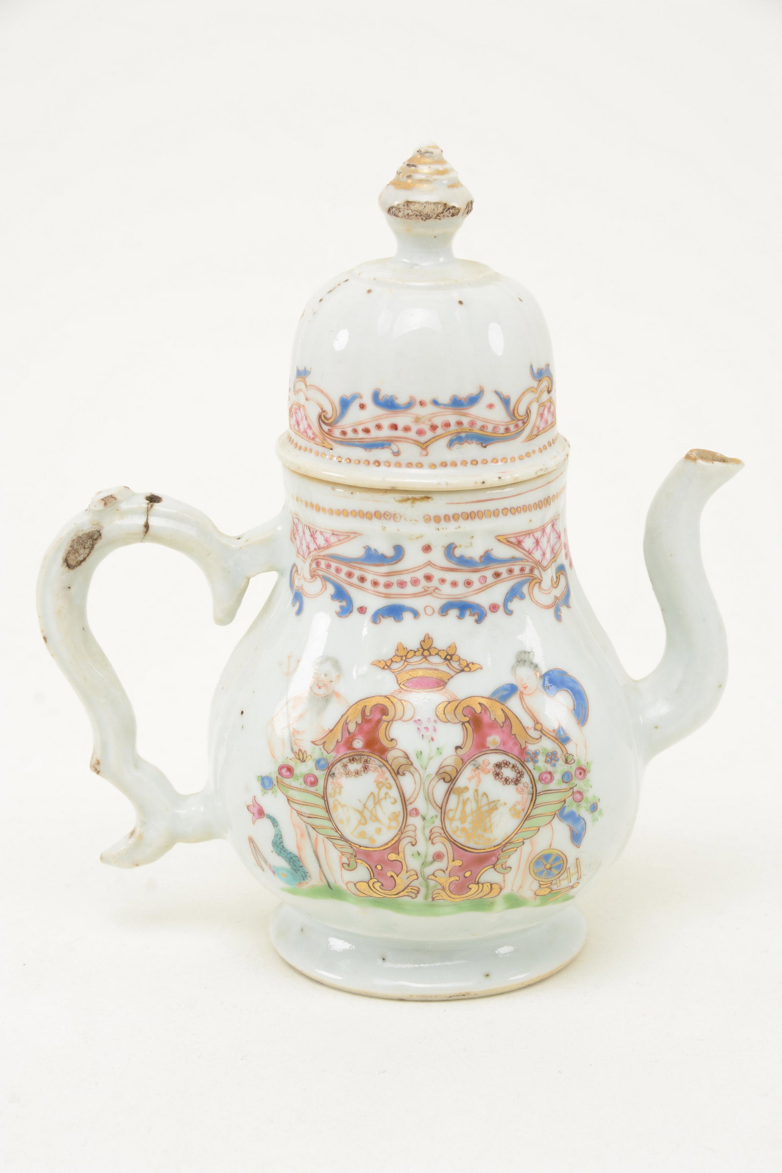 18th Century Chinese export porcelain Teapot. Silver: 18th Century Chinese export porcelain Teapot. Silver form with a molded body. Famille rose armorial decoration and flanking figures a Poseidon ender goddess. 7.75 in. Deep glaze chips to perimeter of 