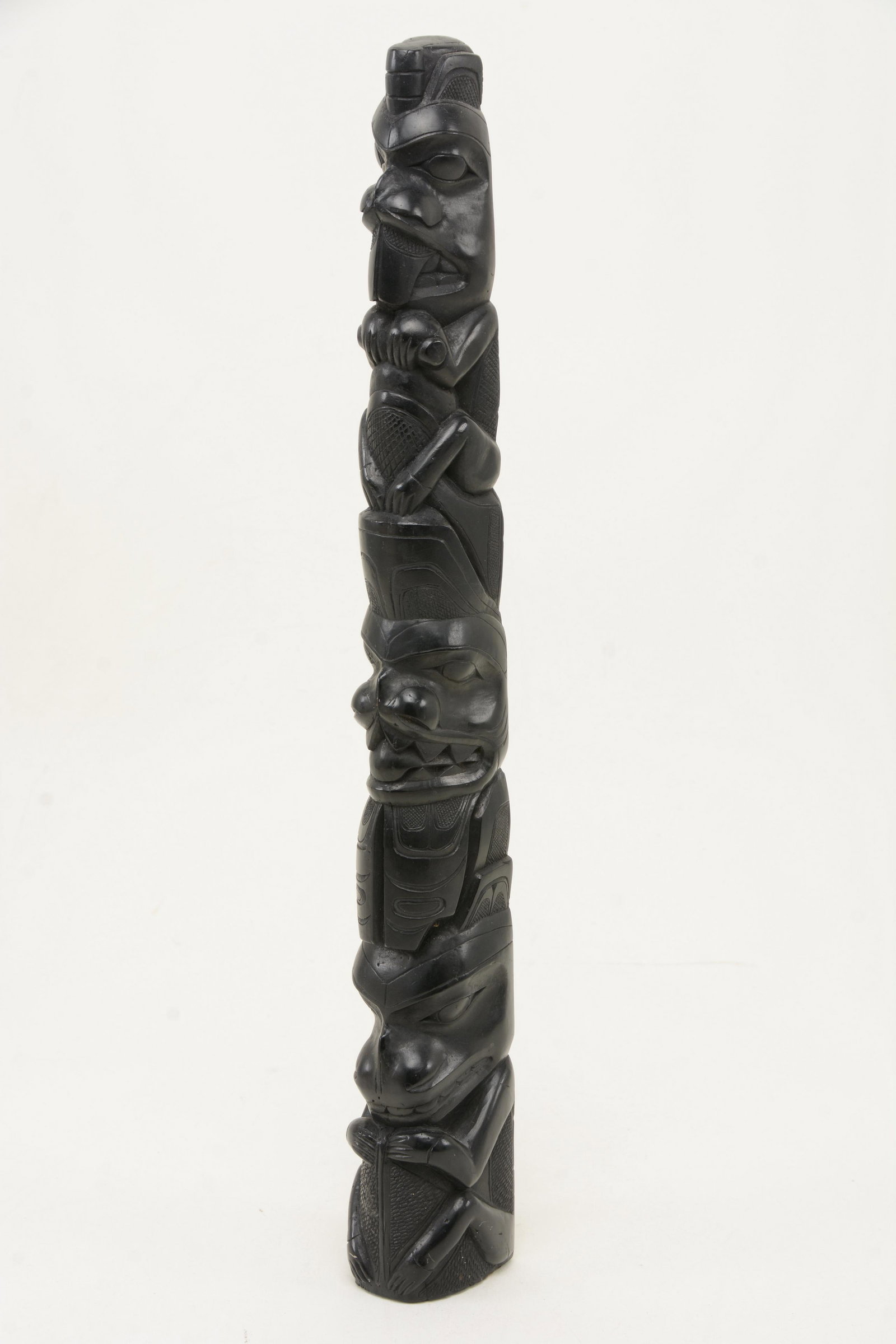Northwest Coast carved argillite totem pole model.: Northwest Coast carved argillite totem pole model. Height 16in.