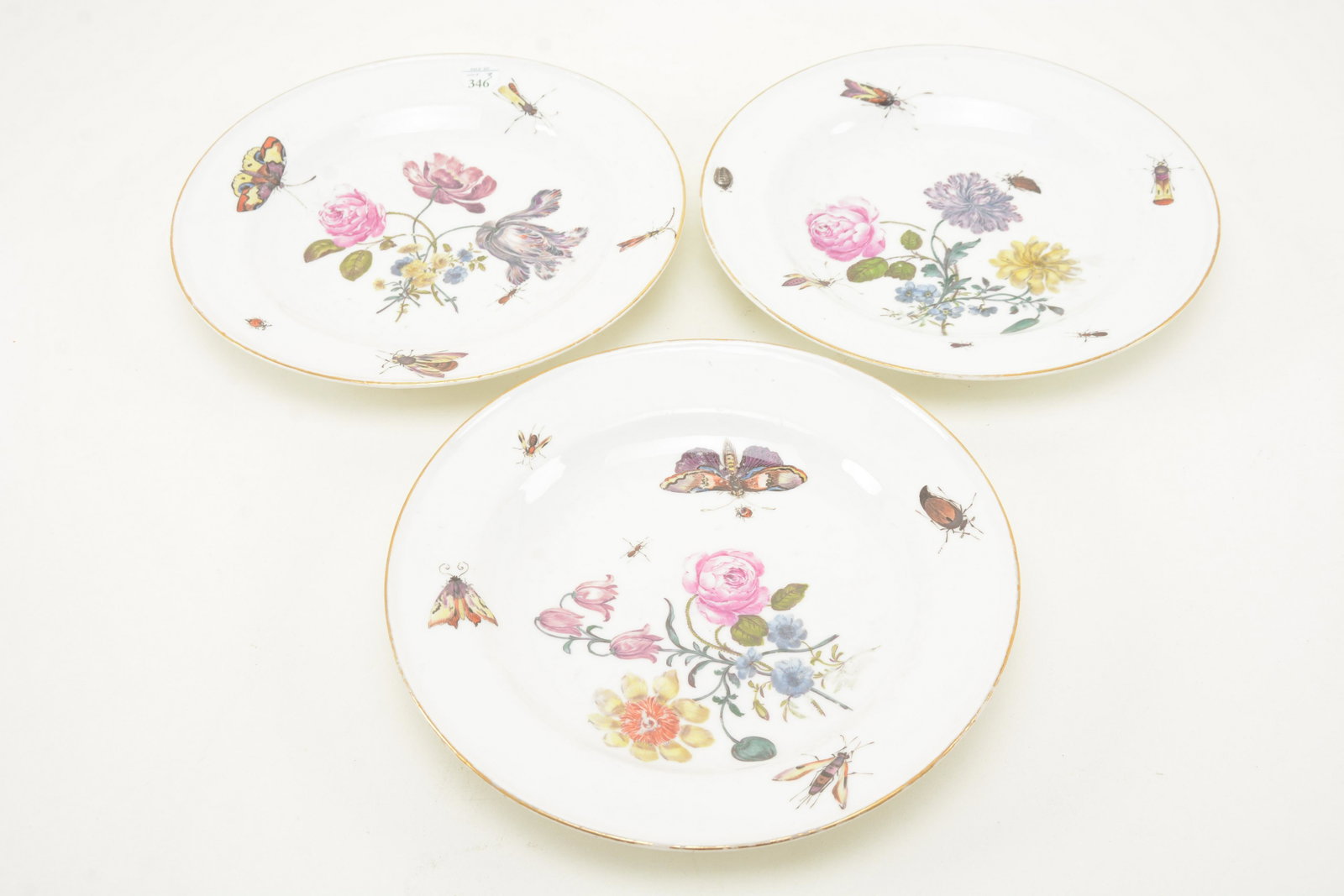 Three early 19th Century Meissen porcelain plates with: Three early 19th Century Meissen porcelain plates with flower and insect decoration. Some wear to decoration. 9.25in diameter