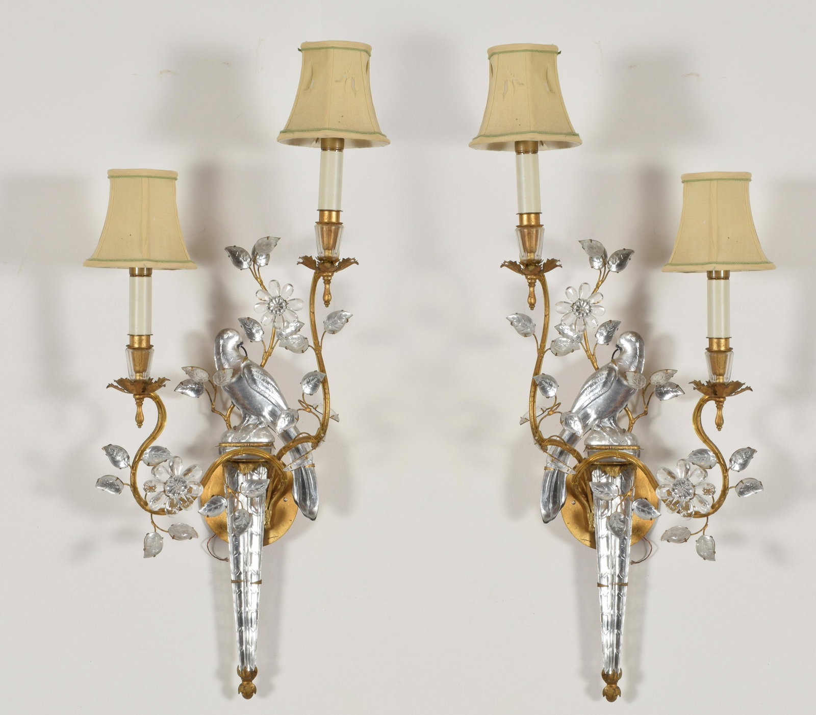 Pair of rock crystal wall sconces. Two arm mirror image: Pair of rock crystal wall sconces. Two arm mirror image sconces with elaborate leaf and floral decorations and central parrot. Gilt candle arms in a staggered height. Possibly rewired. Approximate hei