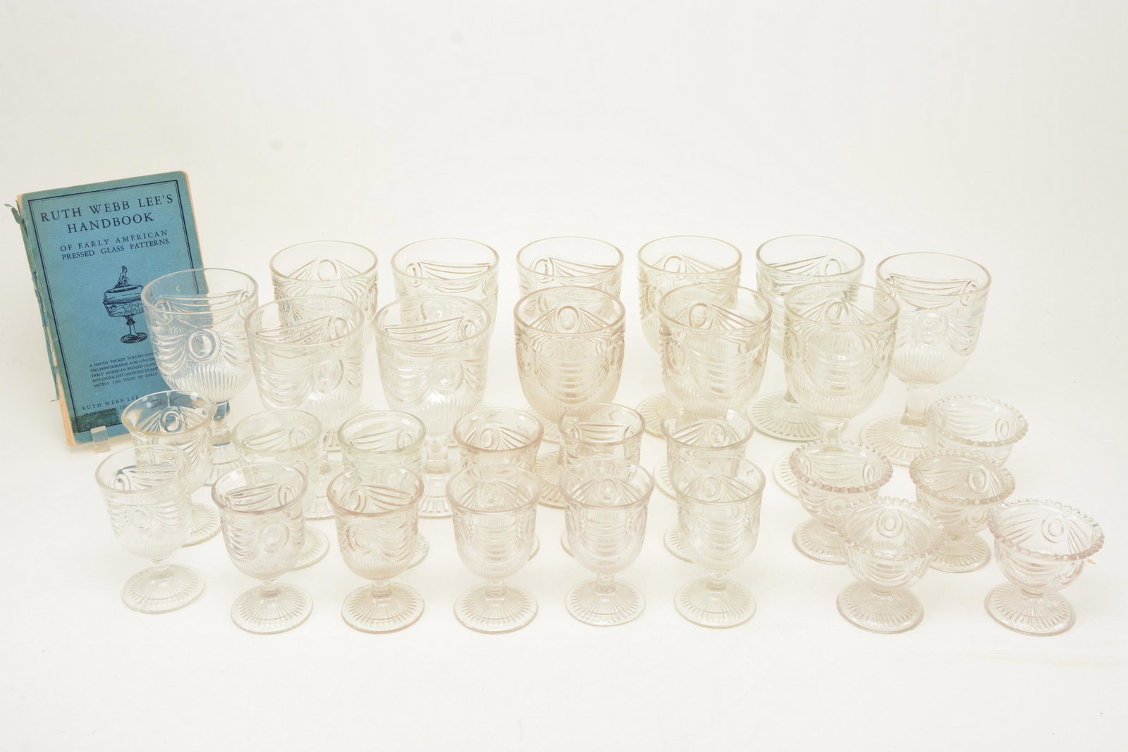 19th century Lincoln Drape glass stemware, thirteen: 19th century Lincoln Drape glass stemware, thirteen goblets, height 6in, twelve wines, height 4in, 5 salt cellars, height 2.75in together with Ruth Webb Leeâ€™s Handbook of Early American Pressed