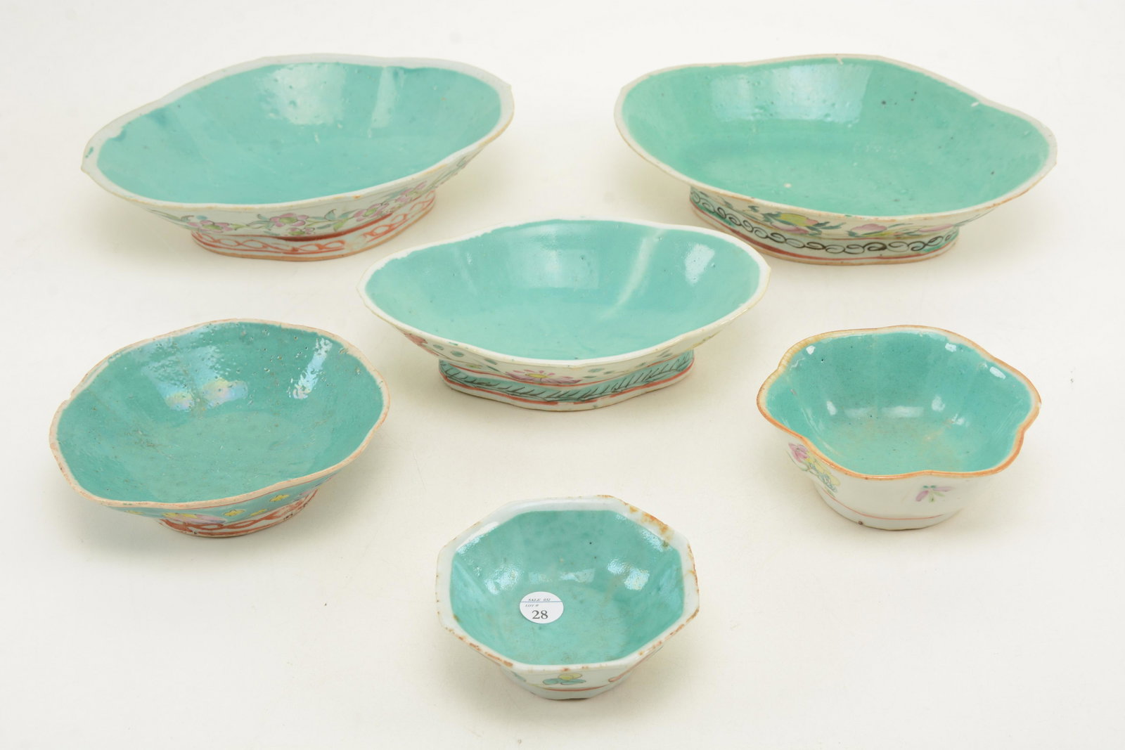 Chinese porcelain footed dishes with turquoise: Chinese porcelain footed dishes with turquoise decorated interiors and floral motifs. Some with rim frits and minor chips. 10 in diameter of largest.