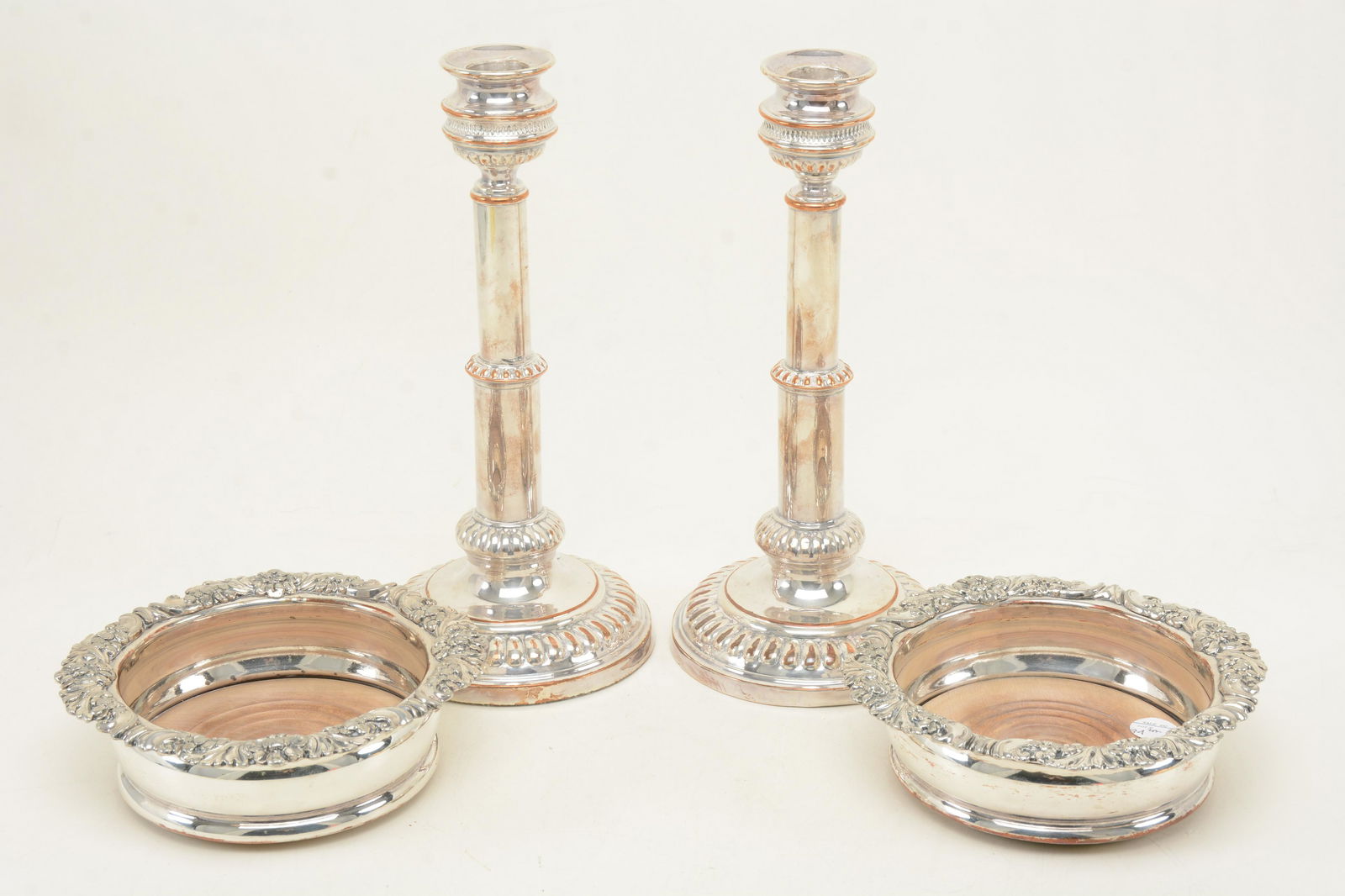 Pair of English silverplate candlesticks, circa 1820.: Pair of English silverplate candlesticks, circa 1820. 10.5in. Together with a pair of wine coasters