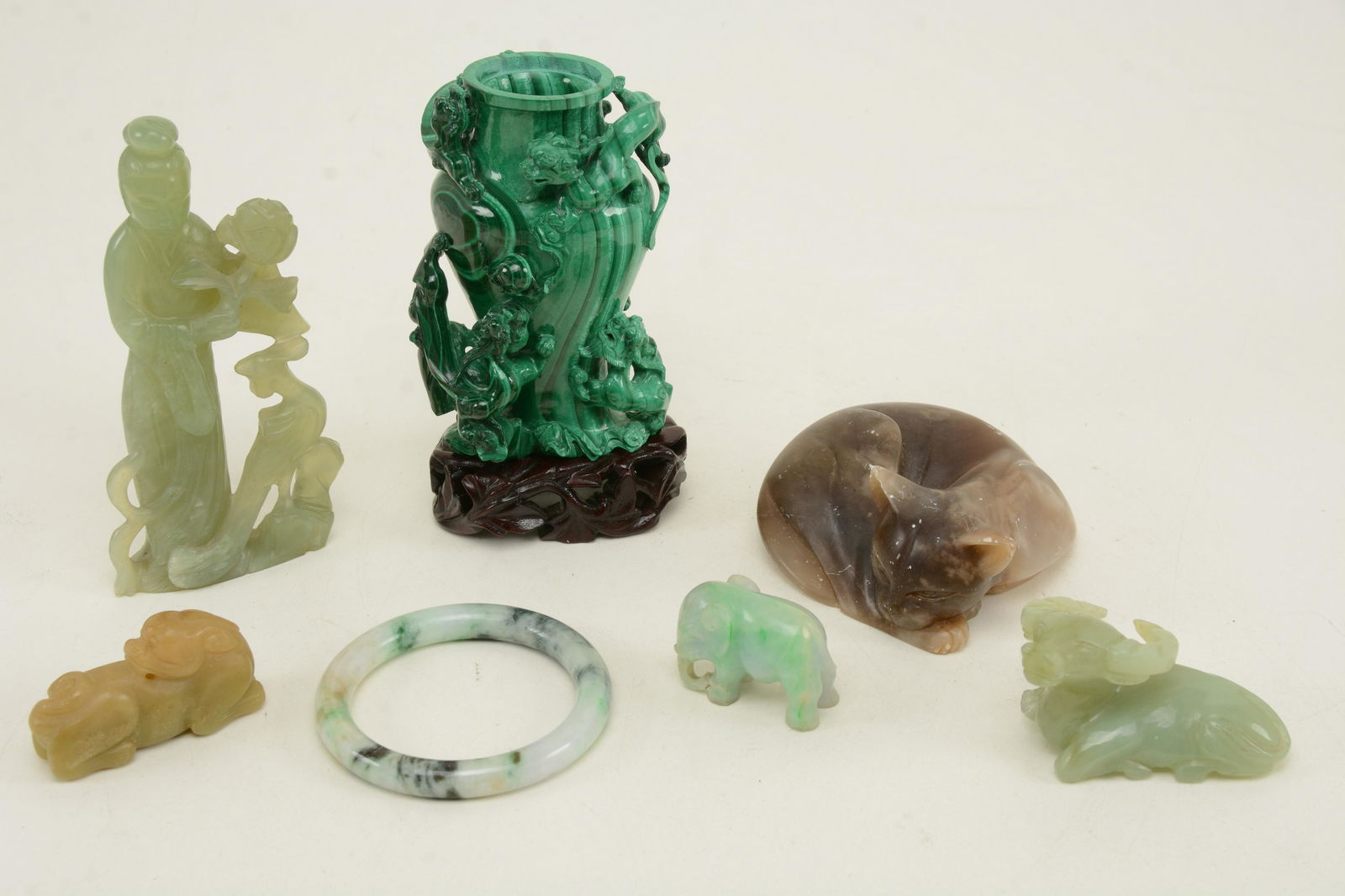 7 Chinese stone carvings. Figure of Guanyin, bangle, (1 of 7)