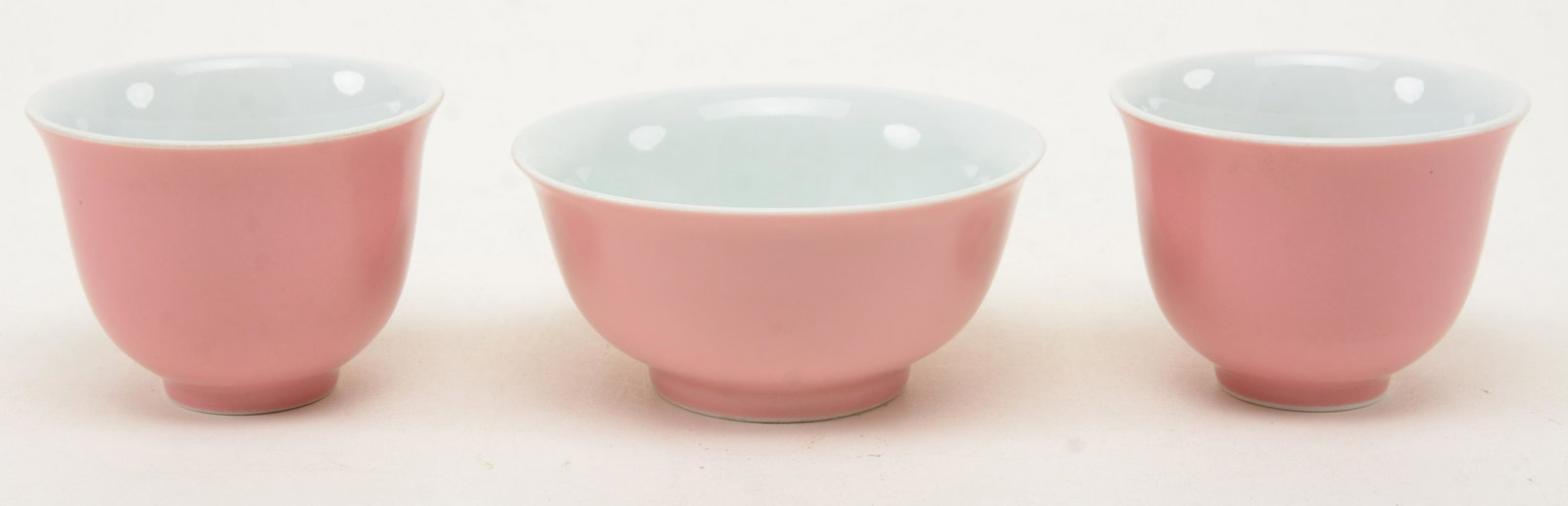 Pair of Pink Enameled Wine Cups and Small Pink Bowl,: Pair of Pink Enameled Wine Cups and Small Pink Bowl, China. Height of cups 2.5 in.