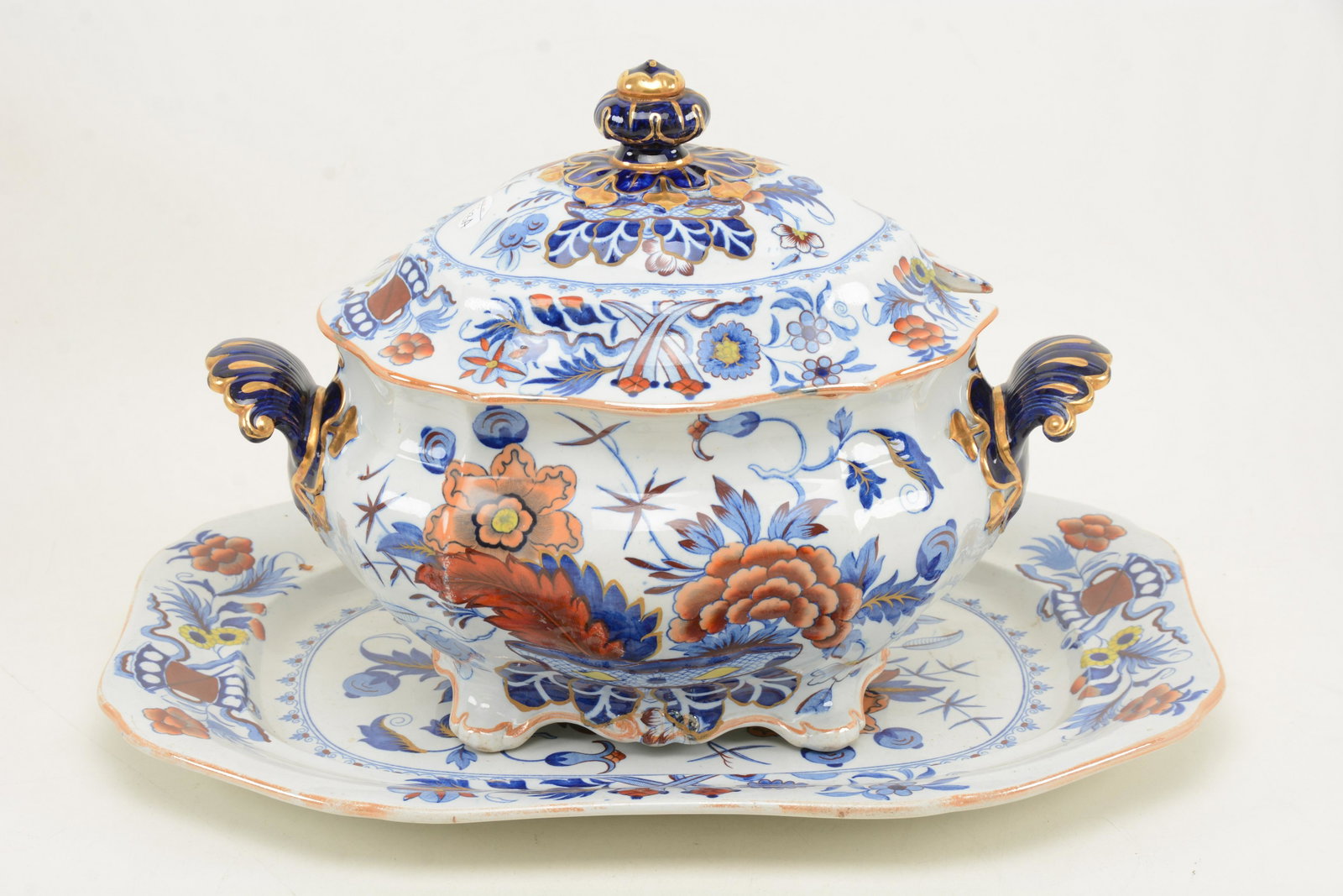 Mid-19th Century Ironstone covered large soup tureen: Mid-19th Century Ironstone covered large soup tureen with rectangular under tray. Body of tureen with stapled repair. Tray in good condition. Tureen; Heght 12 in, width 15 in, tray; 14 x 19 in.