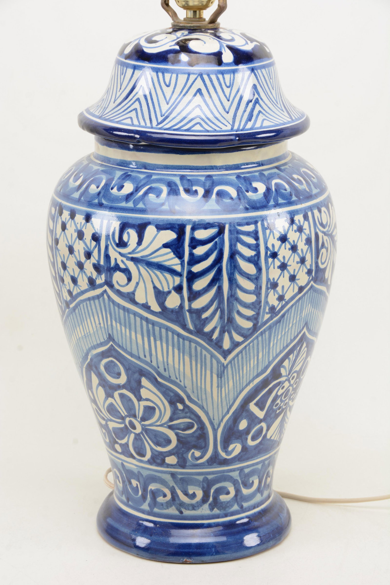 European blue and white faience earthenware jar as a: European blue and white faience earthenware jar as a lamp. Lamp attachment slightly loose with chip and damage to jar. 17.5in height of just vase.