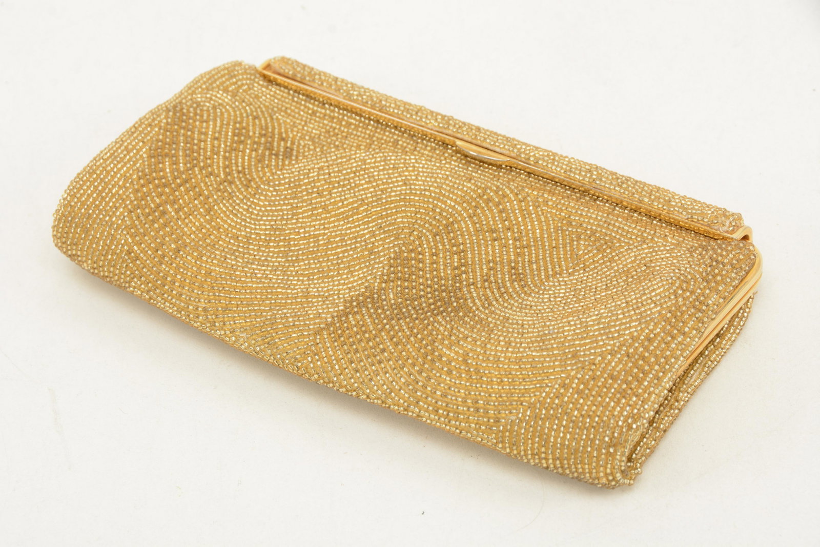 Gucci Beaded Clutch. Minor gaps in beading; water mark: Gucci Beaded Clutch. Minor gaps in beading; water mark to silk lining. 7.25"W x 4.25"H x 1.0"D