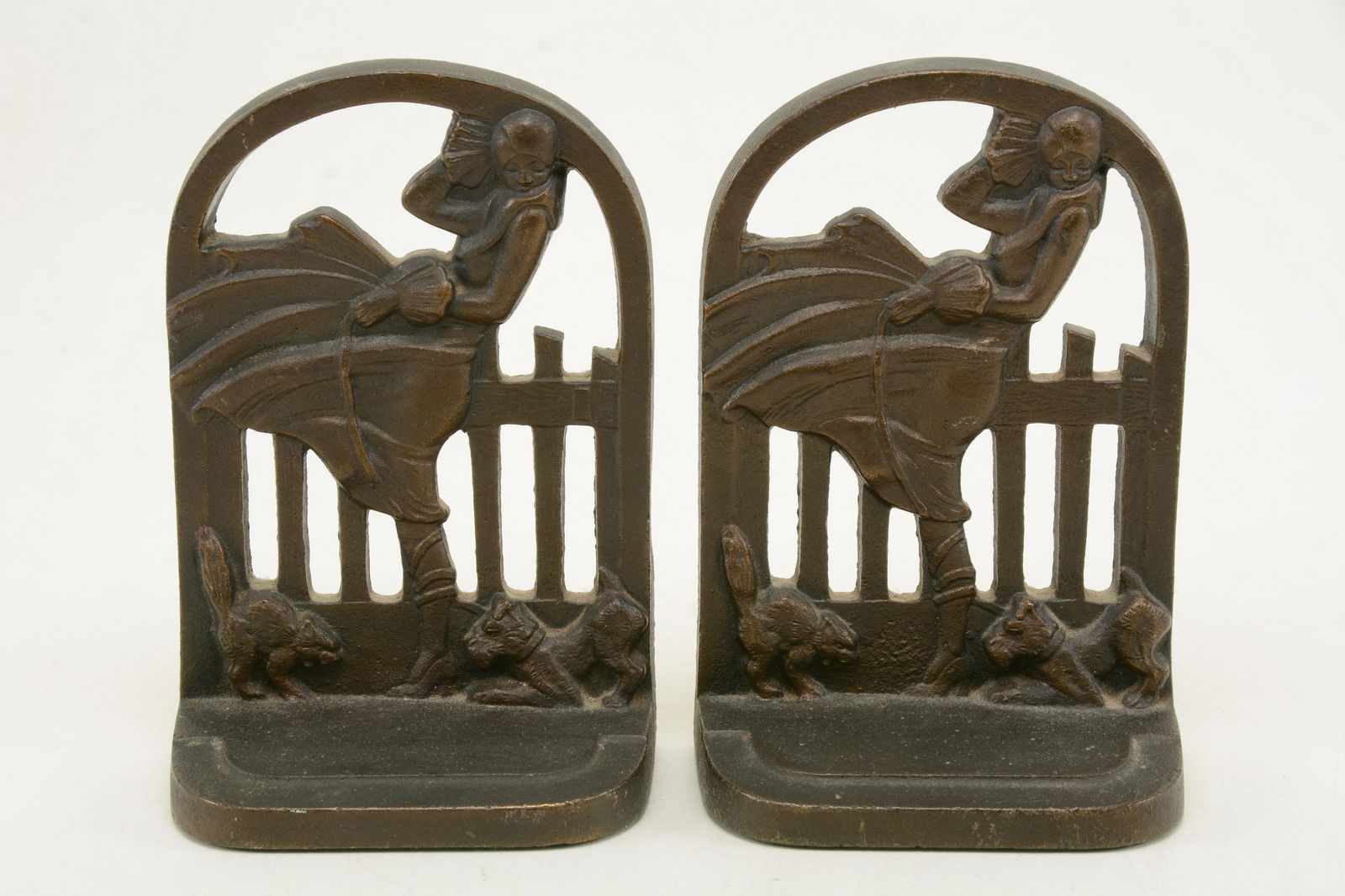 Acorn Company cast iron March Girl art deco style: Acorn Company cast iron March Girl art deco style bookends. Girl in dress walking Scottie dog with cat. Marked with Acorn logo, No. 601, and March Girl to backside of base. 7in height.