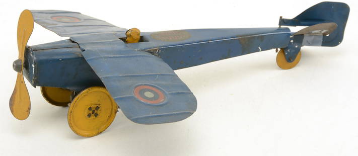 1920s Girard Model Works Woods painted tin mechanical: 1920s Girard Model Works Woods painted tin mechanical toy plane, early 20th century. Blue and yellow paint decorations with graphic to top. With key. Wind up mechanism somewhat functional. Tail fins l