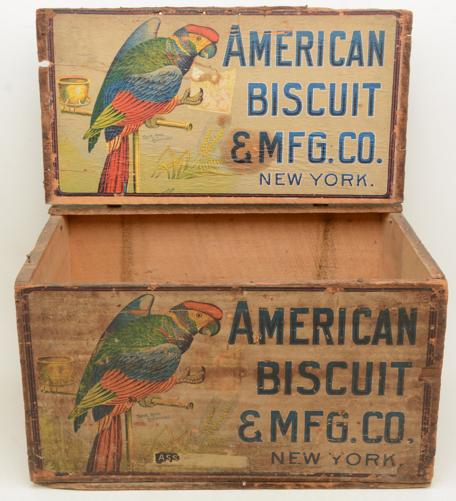 American biscuit box with hinged lid. Original paper: American biscuit box with hinged lid. Original paper label with parrot. 18 x 12 x 10.5 in.