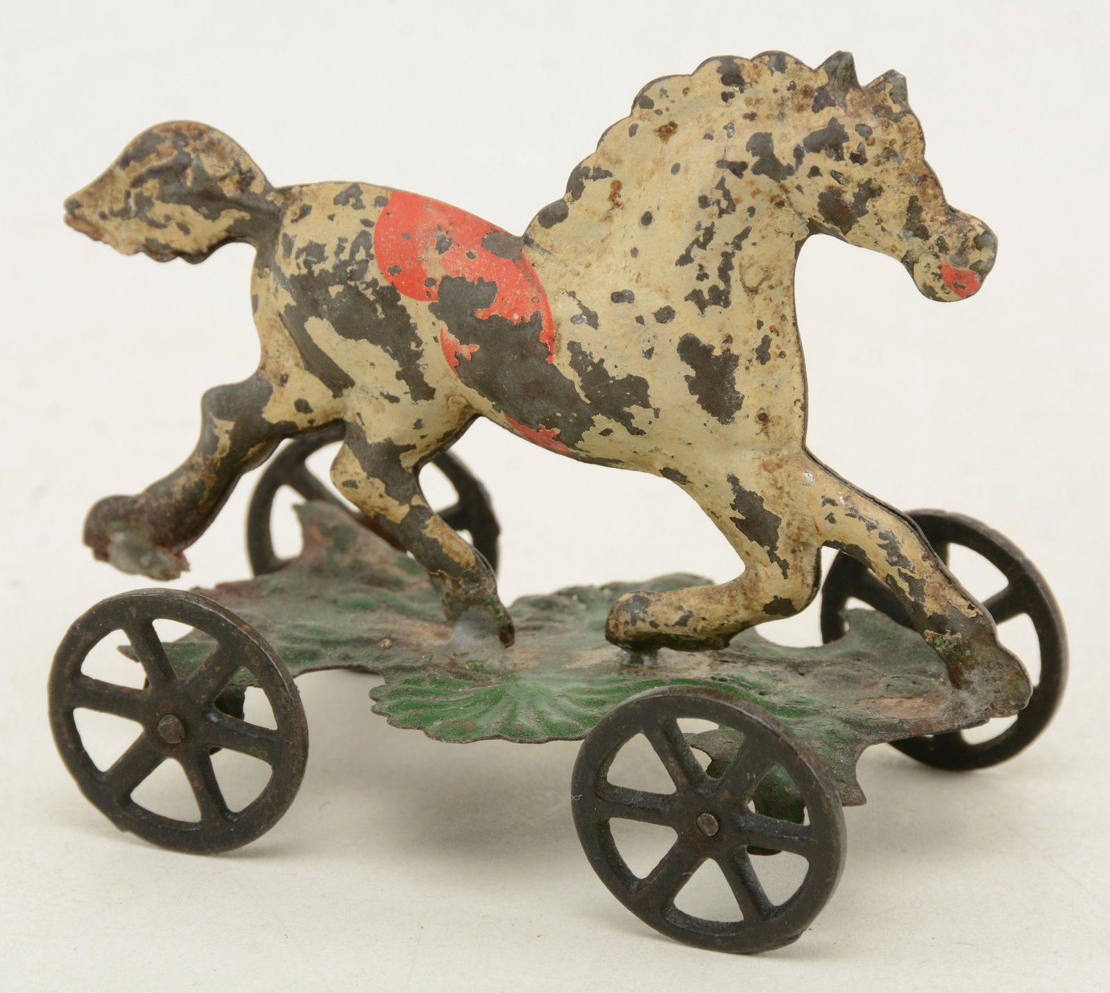 Fallows painted tin horse on platform toy. Cast wheels. (1 of 6)