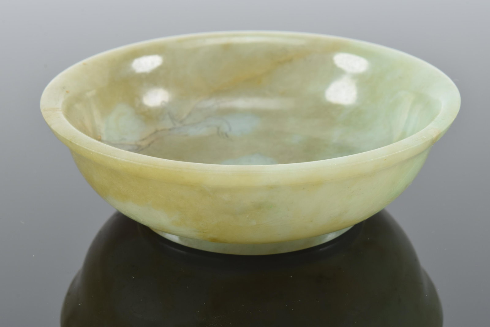 Jade cup. China. 19th century. Surface engraved with: Jade cup. China. 19th century. Surface engraved with prunuses. 4in diameter.