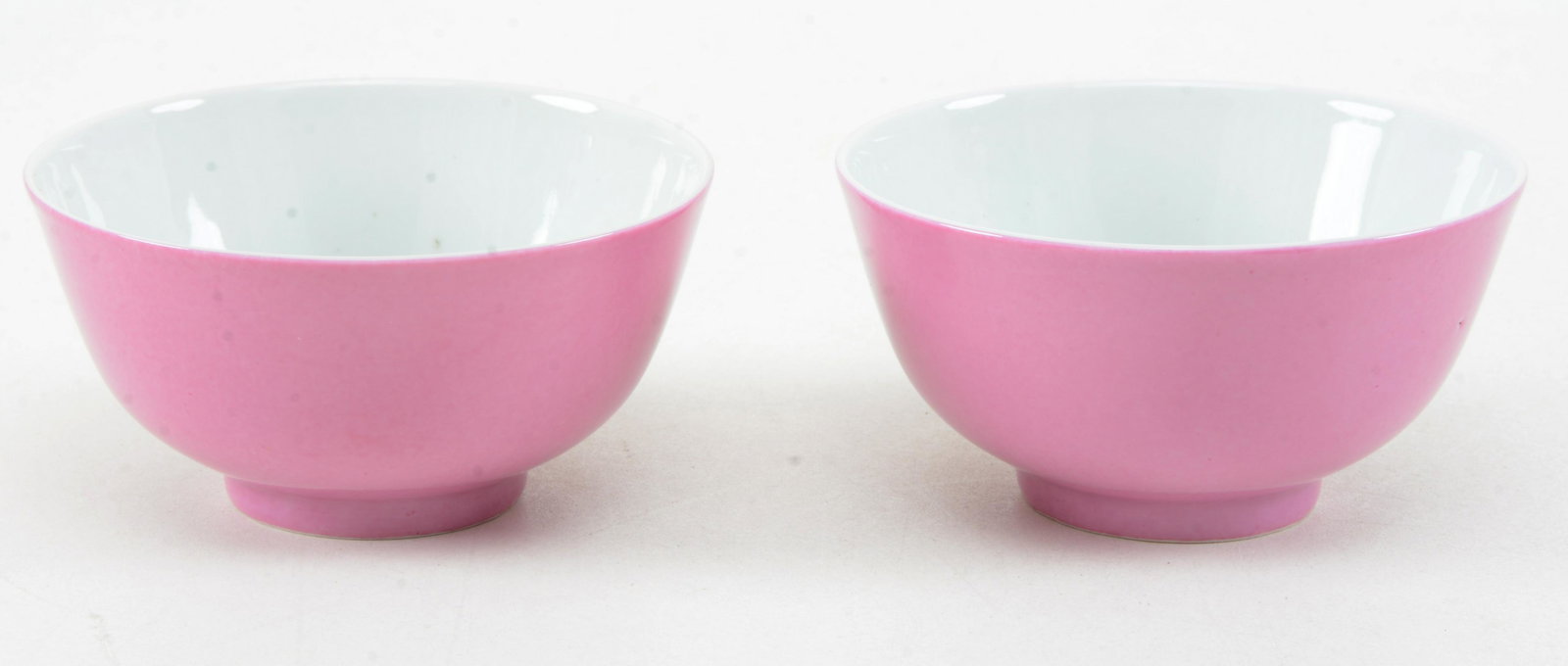 Pair of porcelain cups. Tung Chih mark and possibly of: Pair of porcelain cups. Tung Chih mark and possibly of the period. Monochrome pink glaze. 4 x 2in.