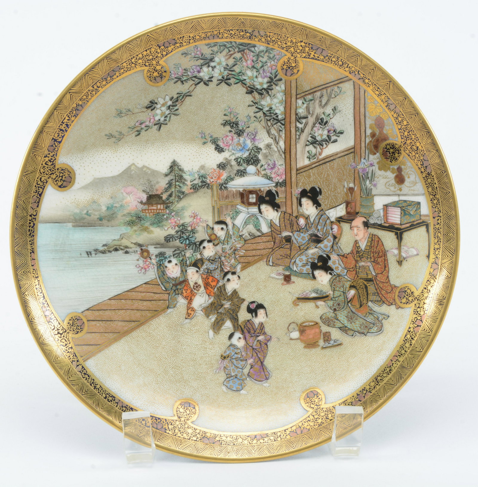 Satsuma plate. Japan. Meiji period. Cobalt blue: Satsuma plate. Japan. Meiji period. Stoneware. Cobalt blue exterior. Interior with woman and children. Signed Kinkozan in gold. 7.25in diameter.