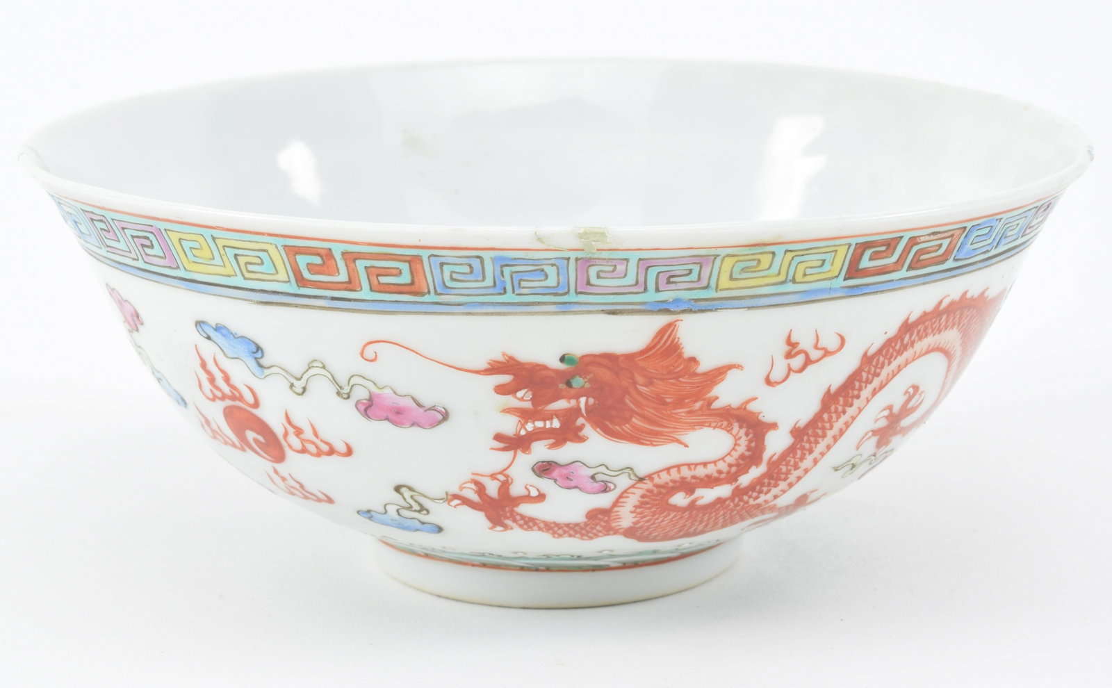 Porcelain bowl. China. 20th century. Decoration of: Porcelain bowl. China. 20th century. Decoration of dragons and phoenixes. Kuang Hsu mark. 6.25in. Repaired chips and cracks.