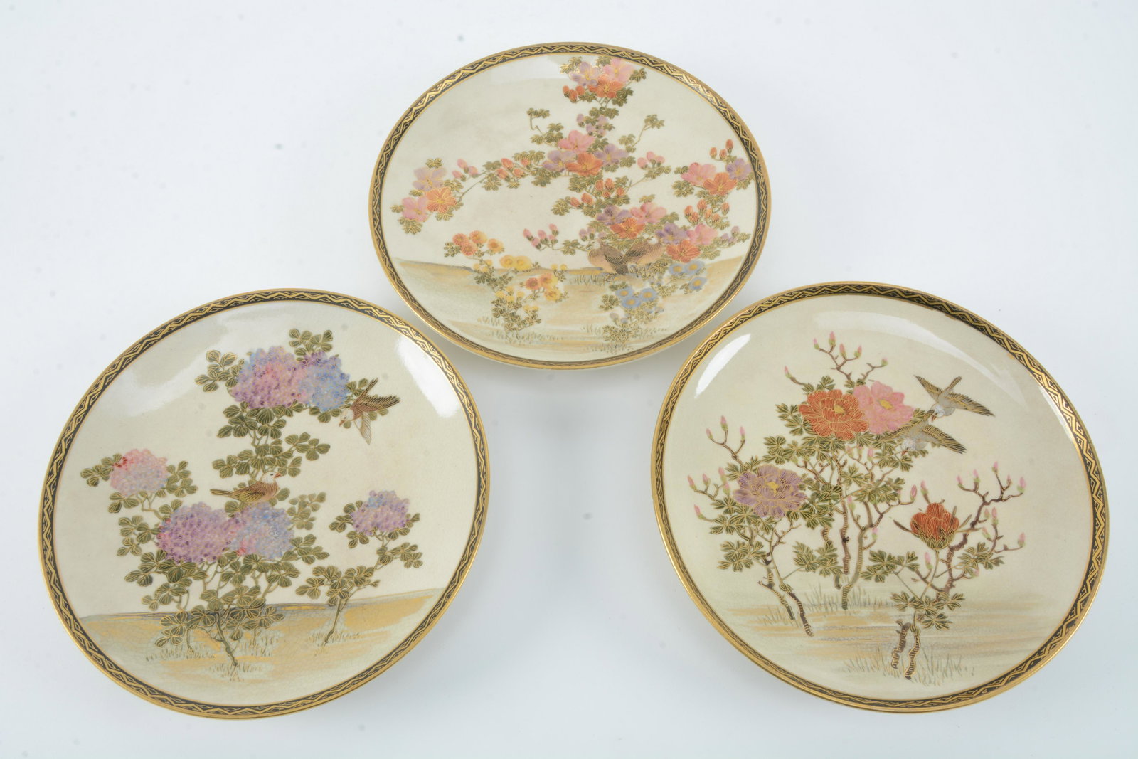 3 Satsuma dishes. Japan. Meiji period (1868-1912).: 3 Satsuma dishes. Japan. Meiji period (1868-1912). Decoration of birds and flowers. 7.25in diameter.