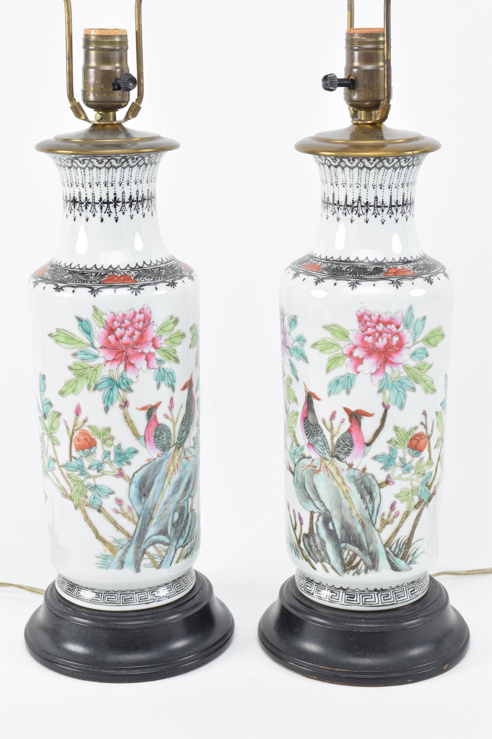 Pair of porcelain vases. China. 20th century.: Pair of porcelain vases. China. 20th century. Cylindrical form. Famille rose decoration of flowers. Chien Lung seal mark on the shoulder. Drilled and mounted as lamps. Vase measures: 13.5in.