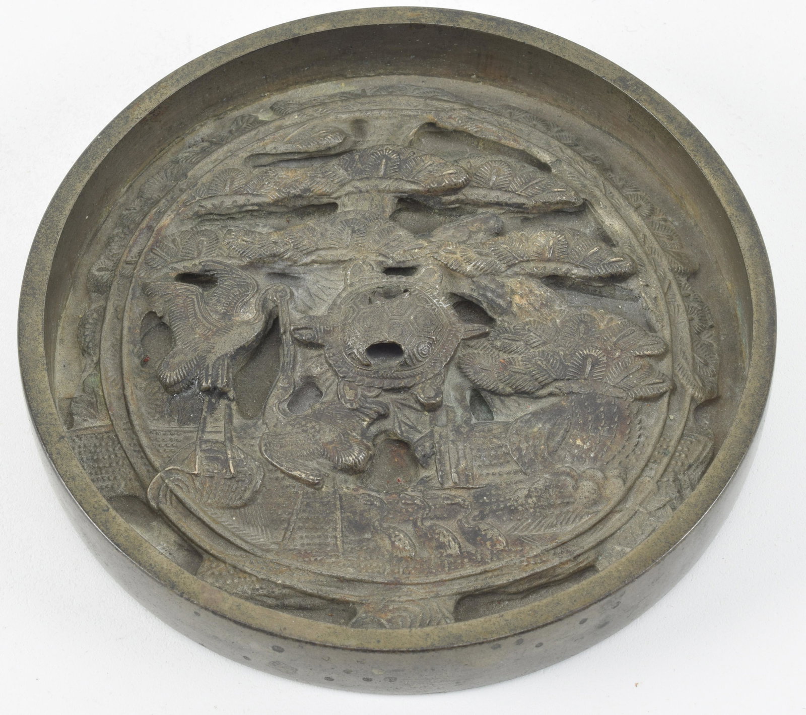 Chinese bronze mirror with relief decoration of turtle: Chinese bronze mirror with relief decoration of turtle and cranes. 5in wide.