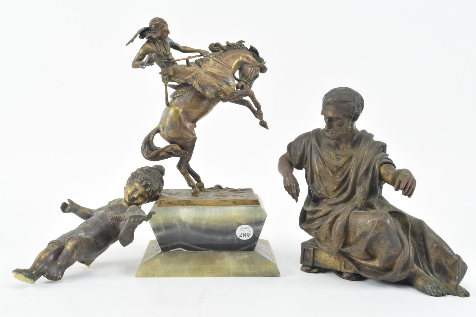 Trio bronze statues including Native American on: Trio bronze statues including Native American on horseback, reclining gentleman, and playful girl. Native American piece is signed illegibly in casting and is 6" x 11.5" x 4.5" including marble base a