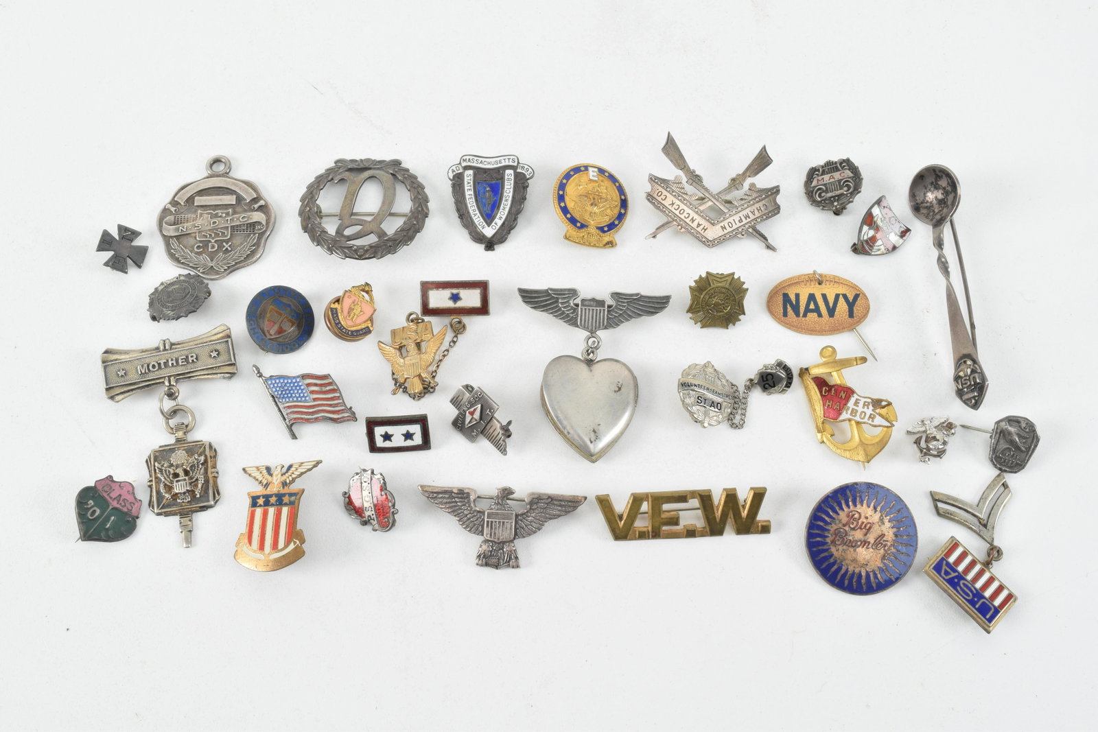 Sterling silver and military pins and medals including: Sterling silver and military pins and medals including M.I.T Engineering, Massachusetts Women's Club, Air Force Sweetheart Locket, and more. Early to Mid 20th Century. Some soiling and surface wear to