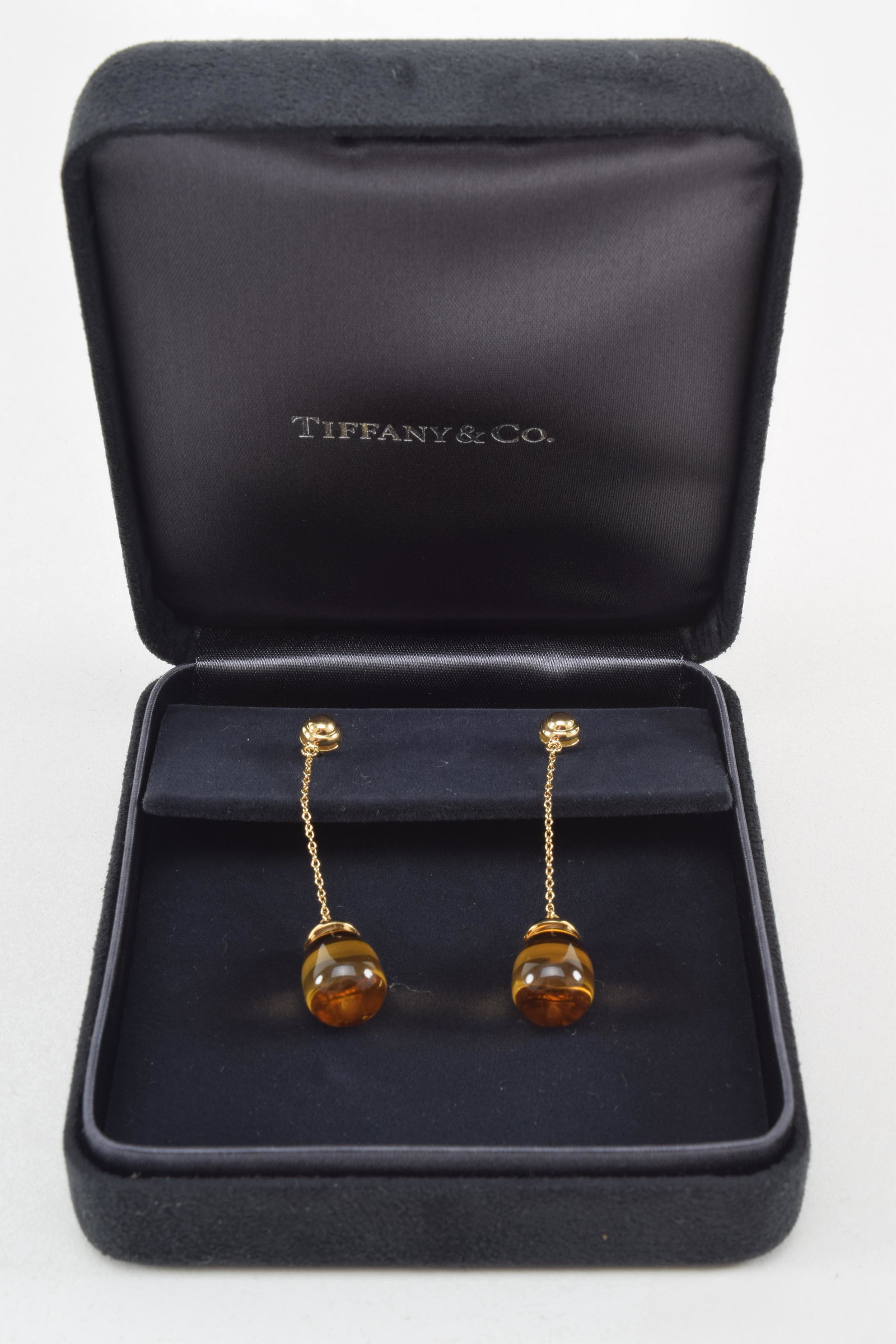 Pair of Tiffany & Co 18K ear pendants, amber stone and: Pair of Tiffany & Co 18K ear pendants, amber stone and fine chain, signed on post, Paloma Picasso T & Co 750. In fitted box.