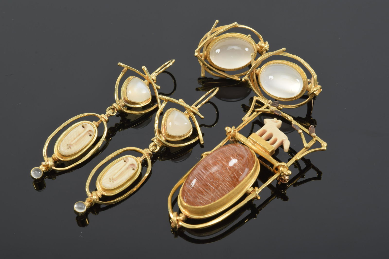 Carolyn Morris Bach, 18K and 22K gold carved bone and: Carolyn Morris Bach, 18K and 22K gold carved bone and amber fanciful pin and pair of gold moonstone and figural bone earrings. Pin signed and dated 2004. Along with a pair of gold and moonstone earrin