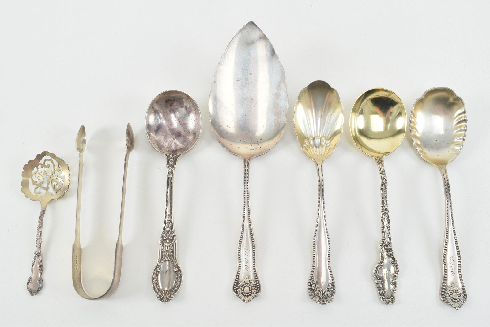 Sterling silver serving utensils. To include: 1) shaped (1 of 11)